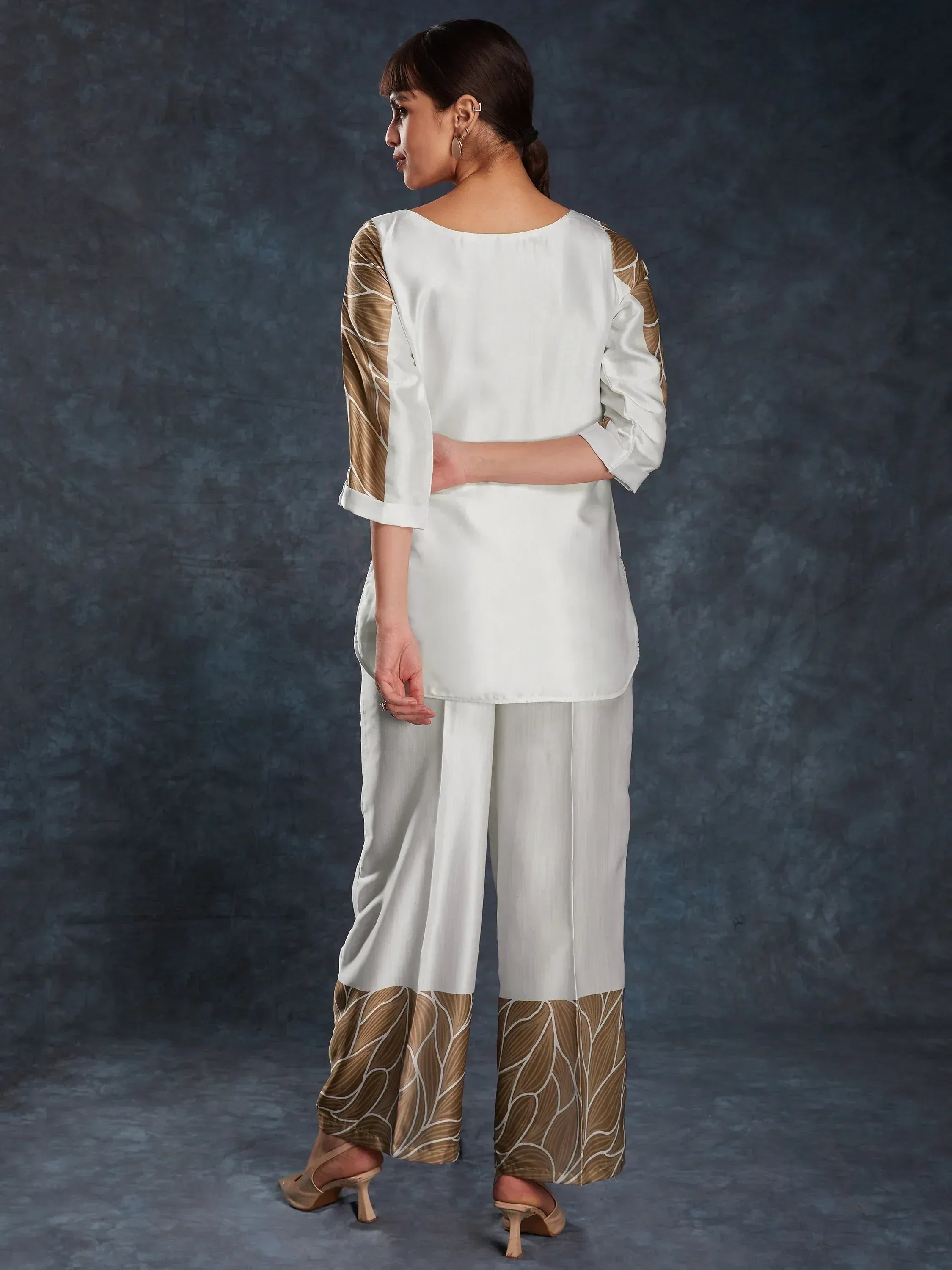 White ethnic salwar kameez with gold leaf print sleeves and pants, stylish Indian wear for women
