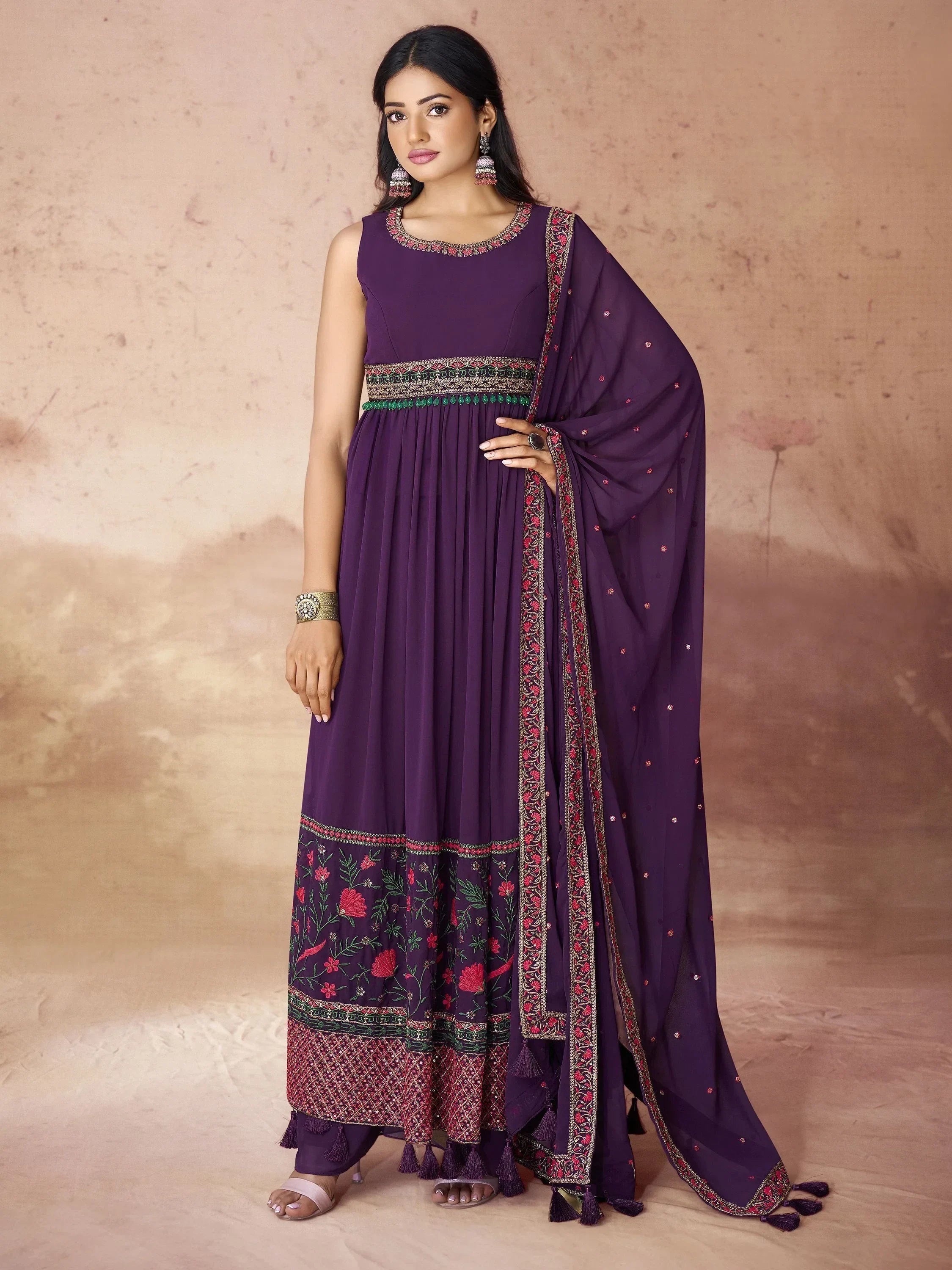 Woman wearing purple embroidered Indian ethnic gown with dupatta and floral patterns