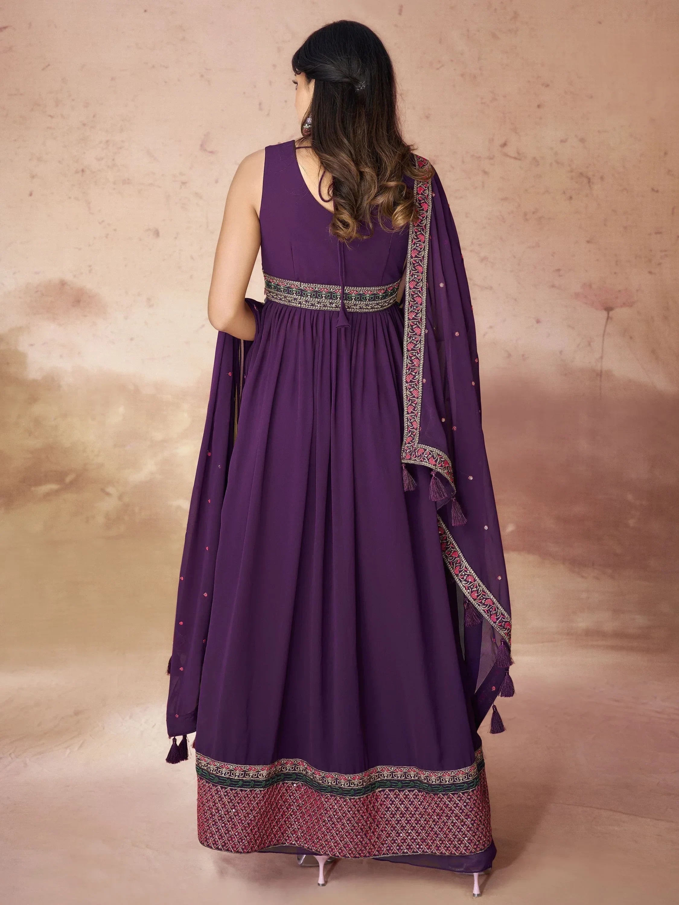 Woman in purple embroidered ethnic gown with dupatta, back view, Indian festive wear