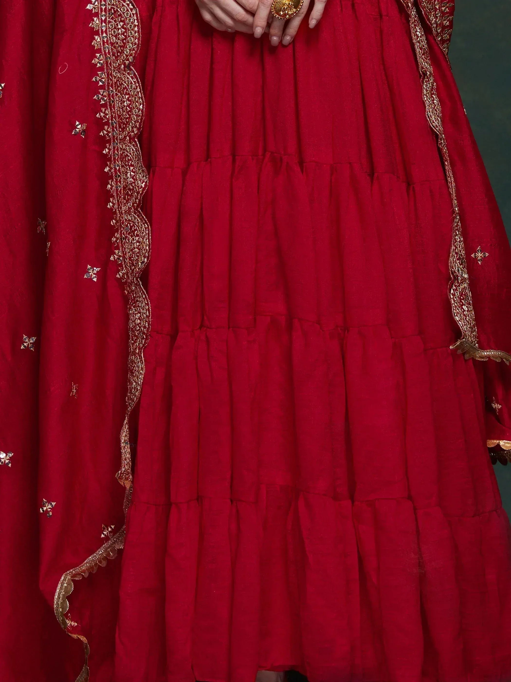 Red ethnic lehenga with gold embroidery and pleated skirt, perfect for Indian weddings and festivals