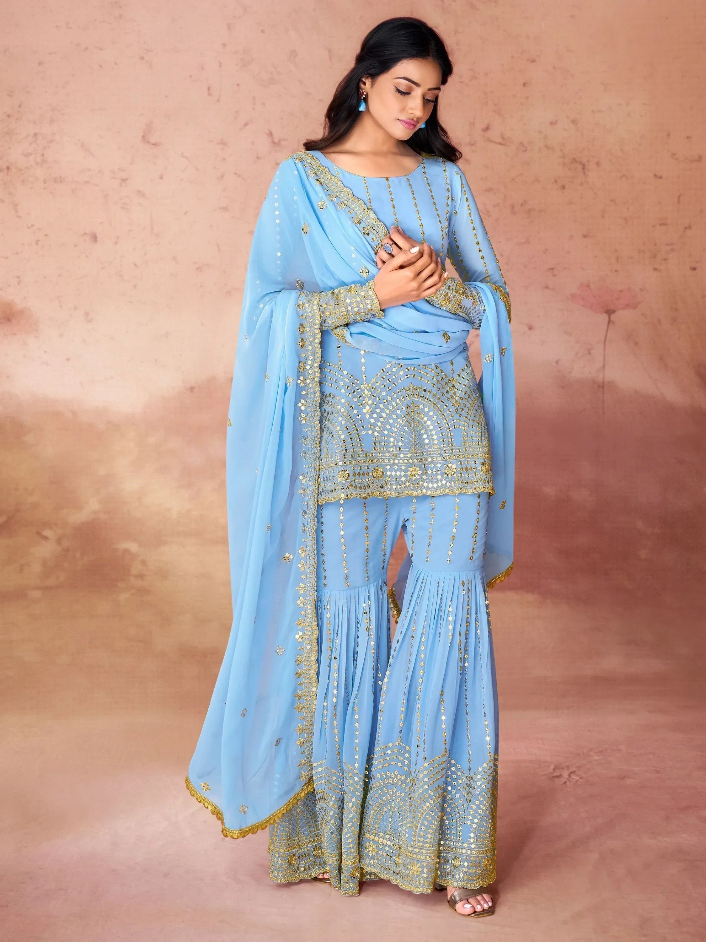 Woman wearing light blue embroidered sharara suit with dupatta, Indian ethnic fashion