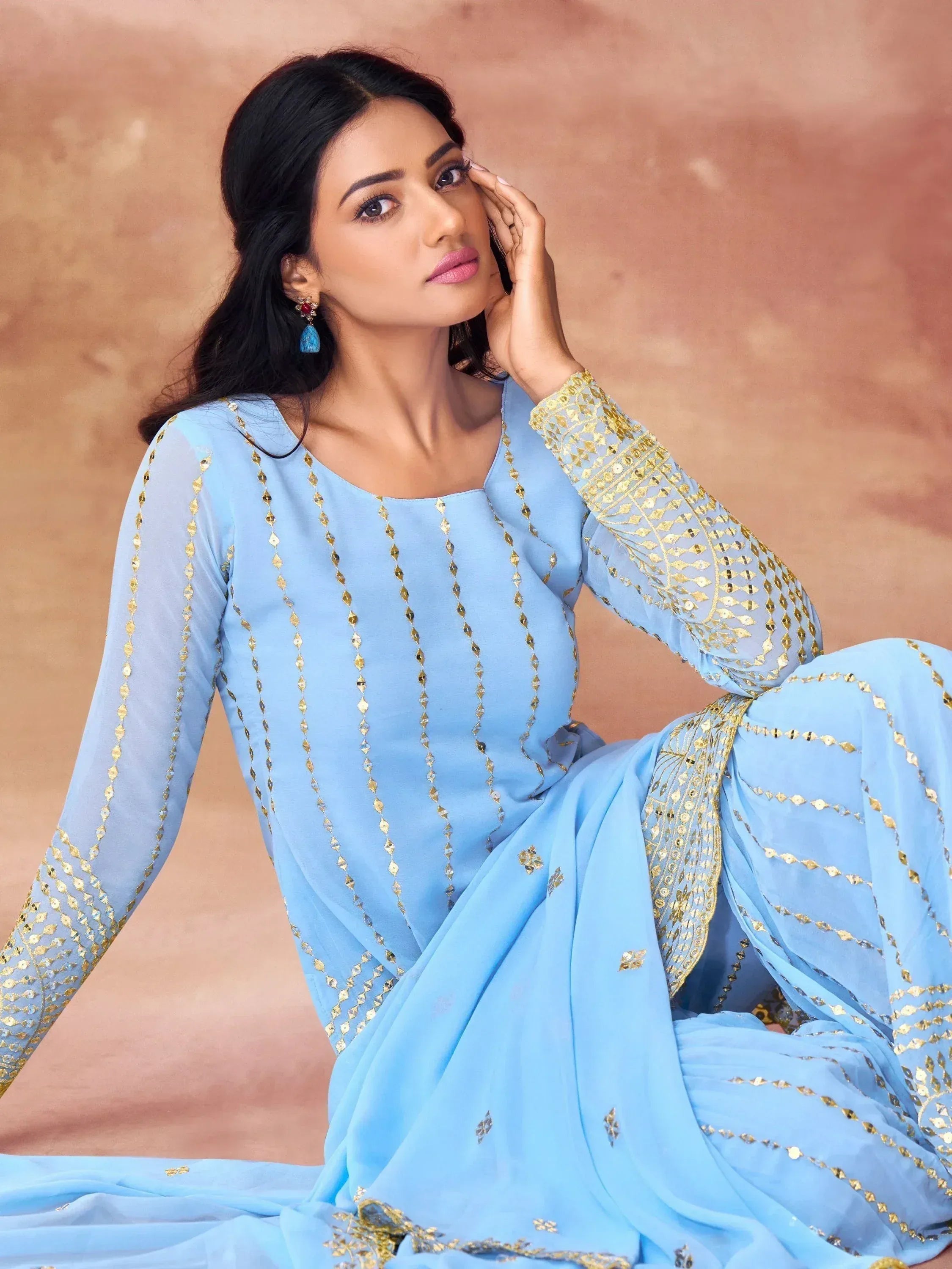 Light blue ethnic gown with gold embroidery, perfect for Indian occasions and festive wear.