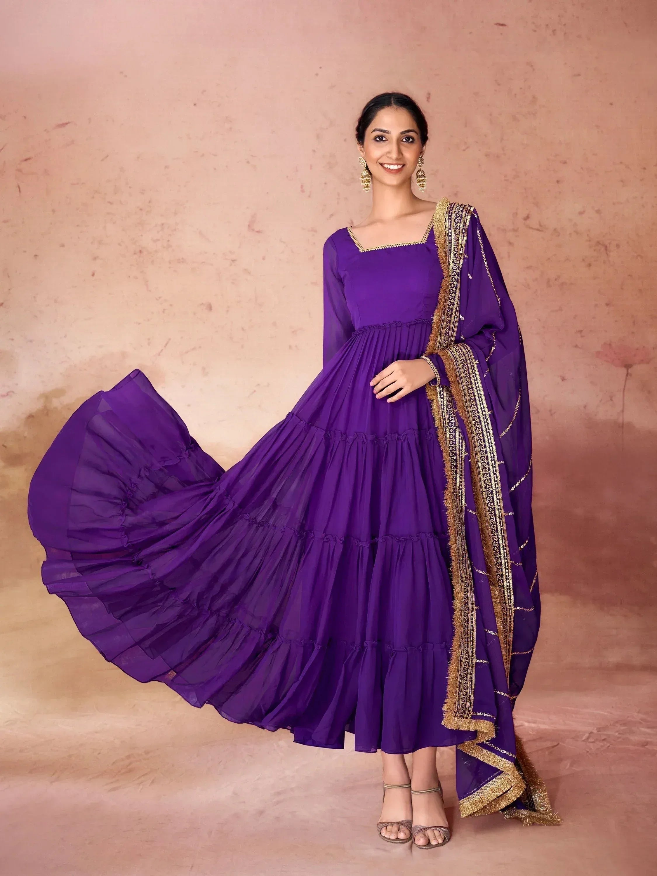 Woman in a purple Anarkali gown with gold embroidered dupatta, Indian ethnic wear