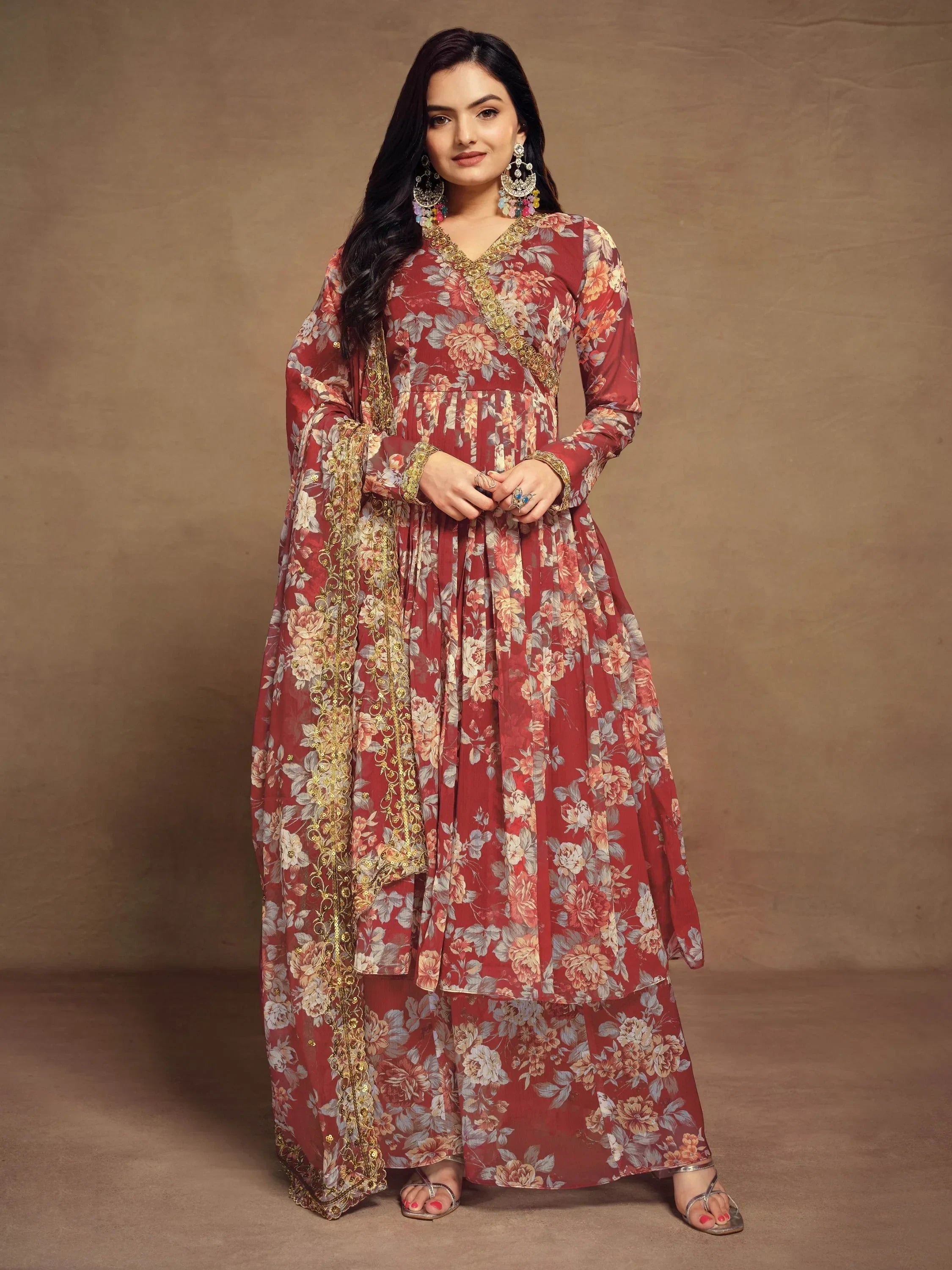 Woman wearing maroon floral printed ethnic gown with dupatta, gold border detailing