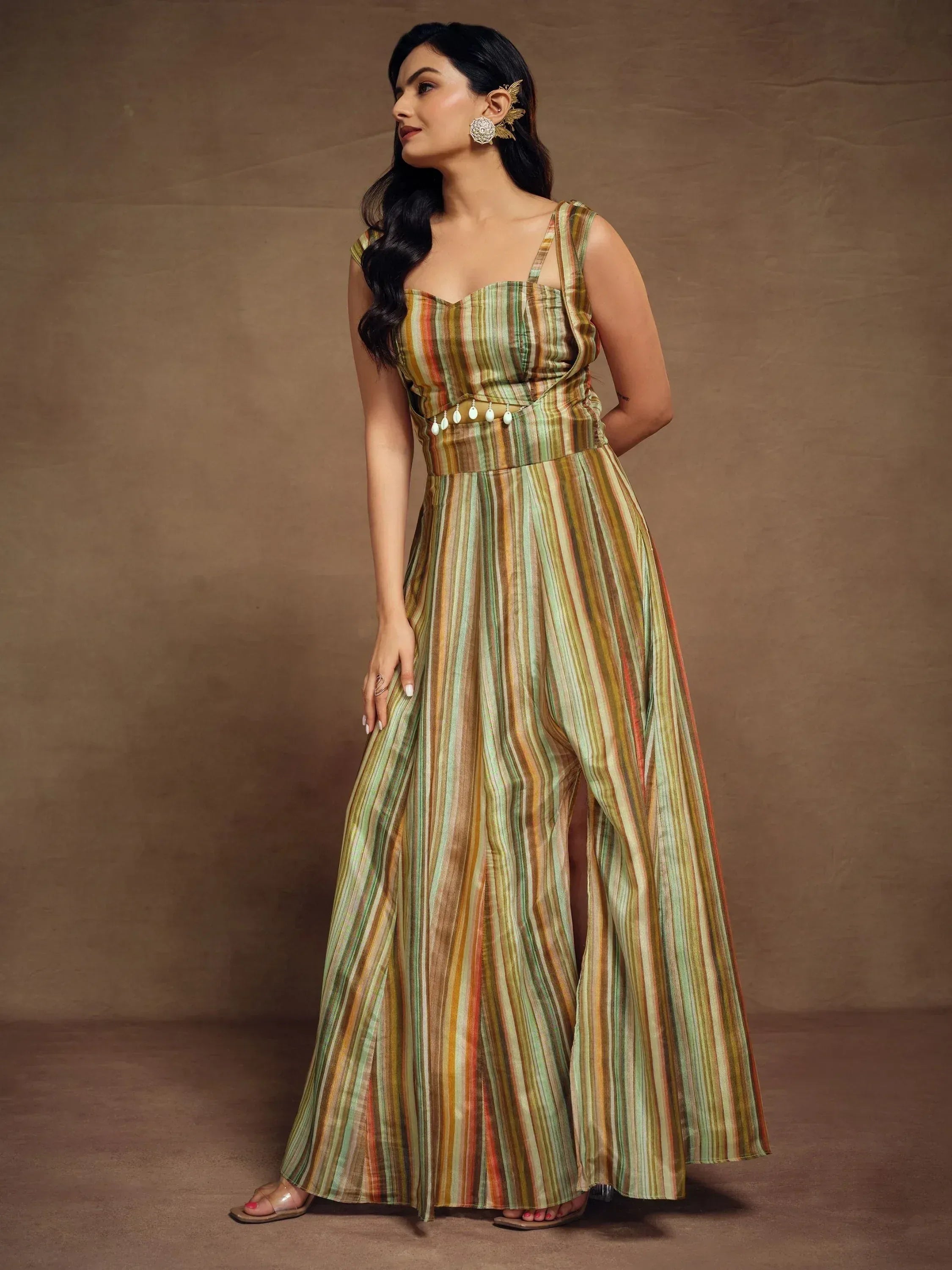 Woman in striped ethnic gown with side slit, perfect for Indian occasions and festive wear.