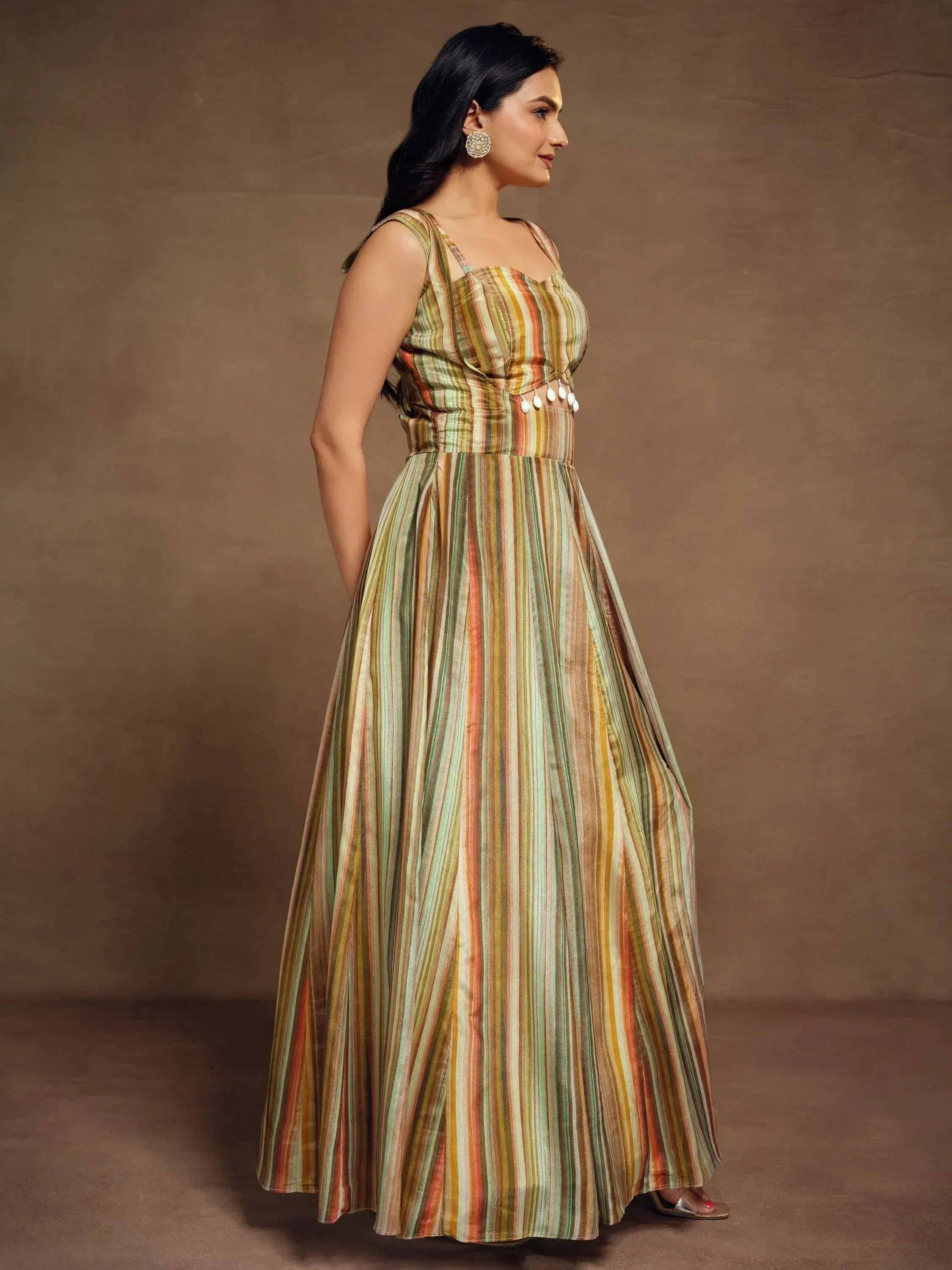 Striped ethnic gown with pom-pom details, perfect for Indian festive occasions and parties.