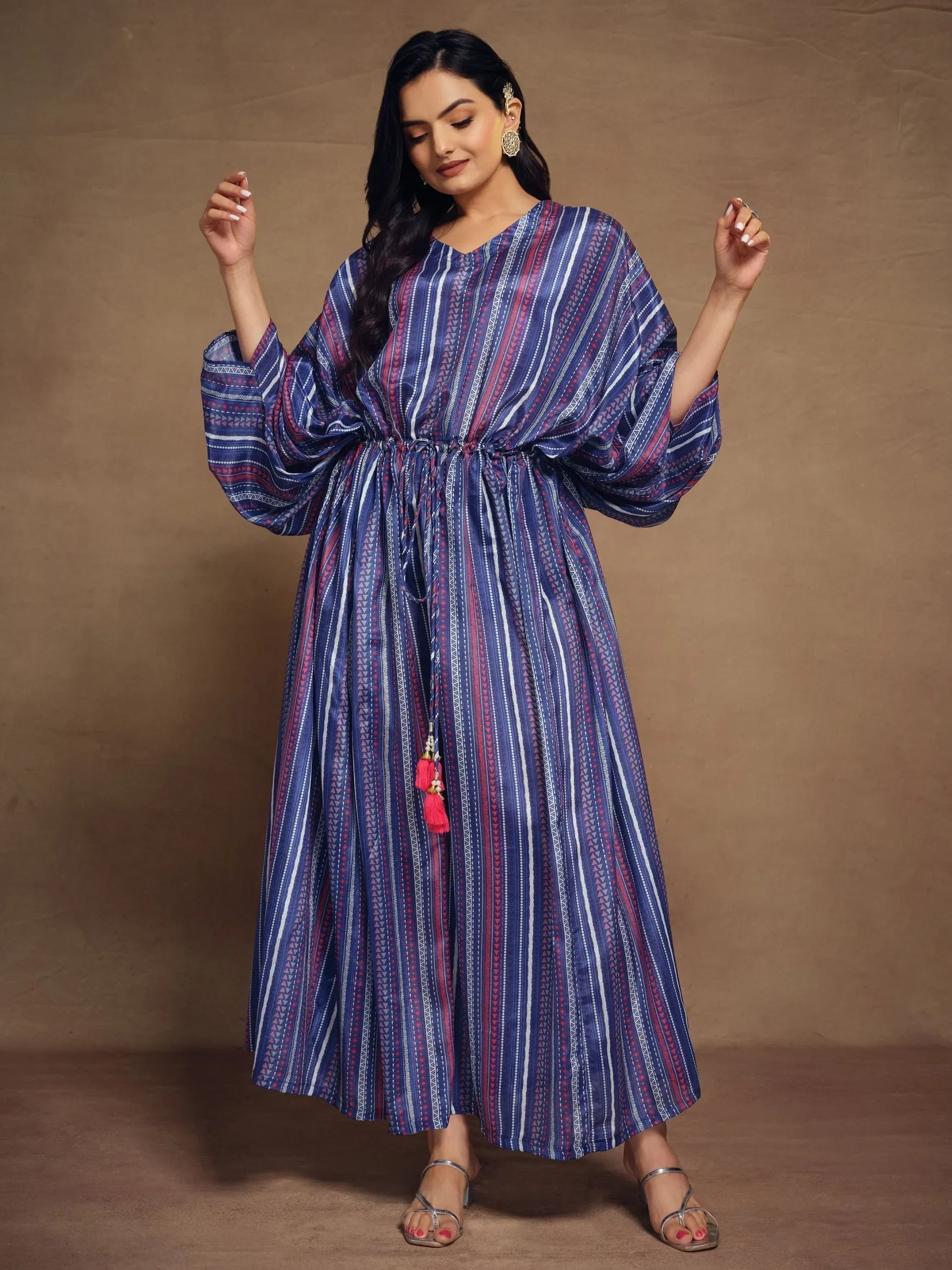 Woman in a blue and purple striped ethnic kaftan dress with drawstring waist
