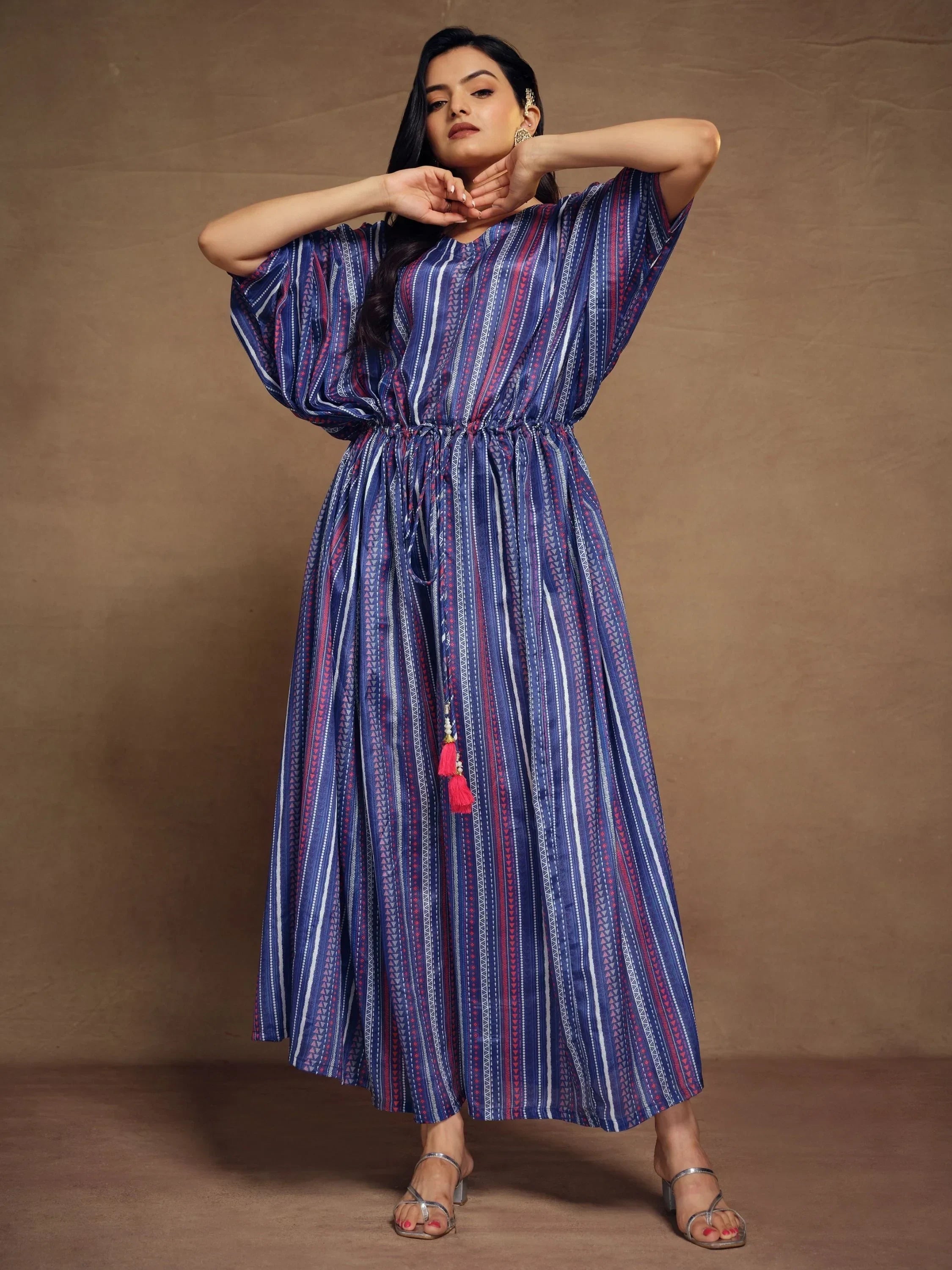Woman wearing a blue and purple striped ethnic gown with drawstring waist and tassels