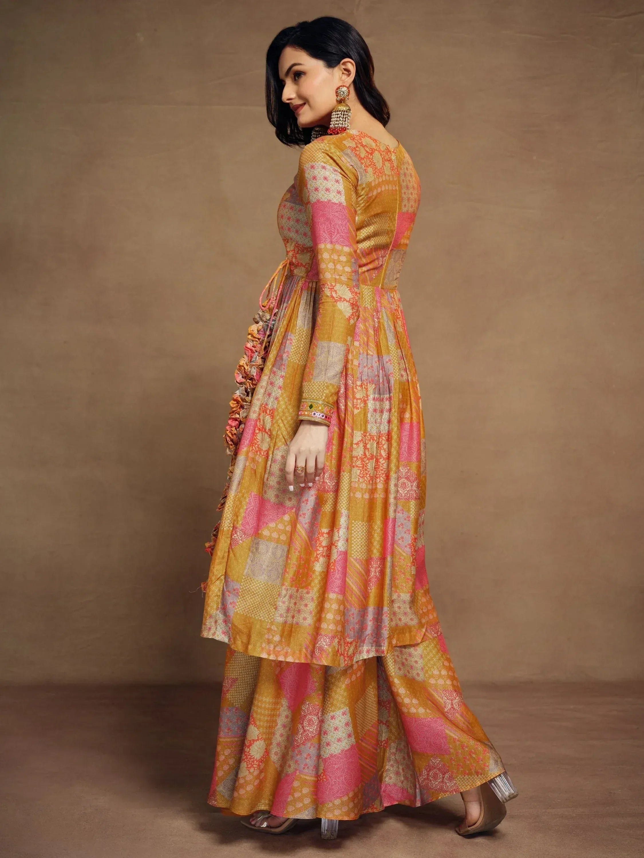 Vibrant patchwork ethnic gown with floral patterns and ruffled detailing for festive occasions