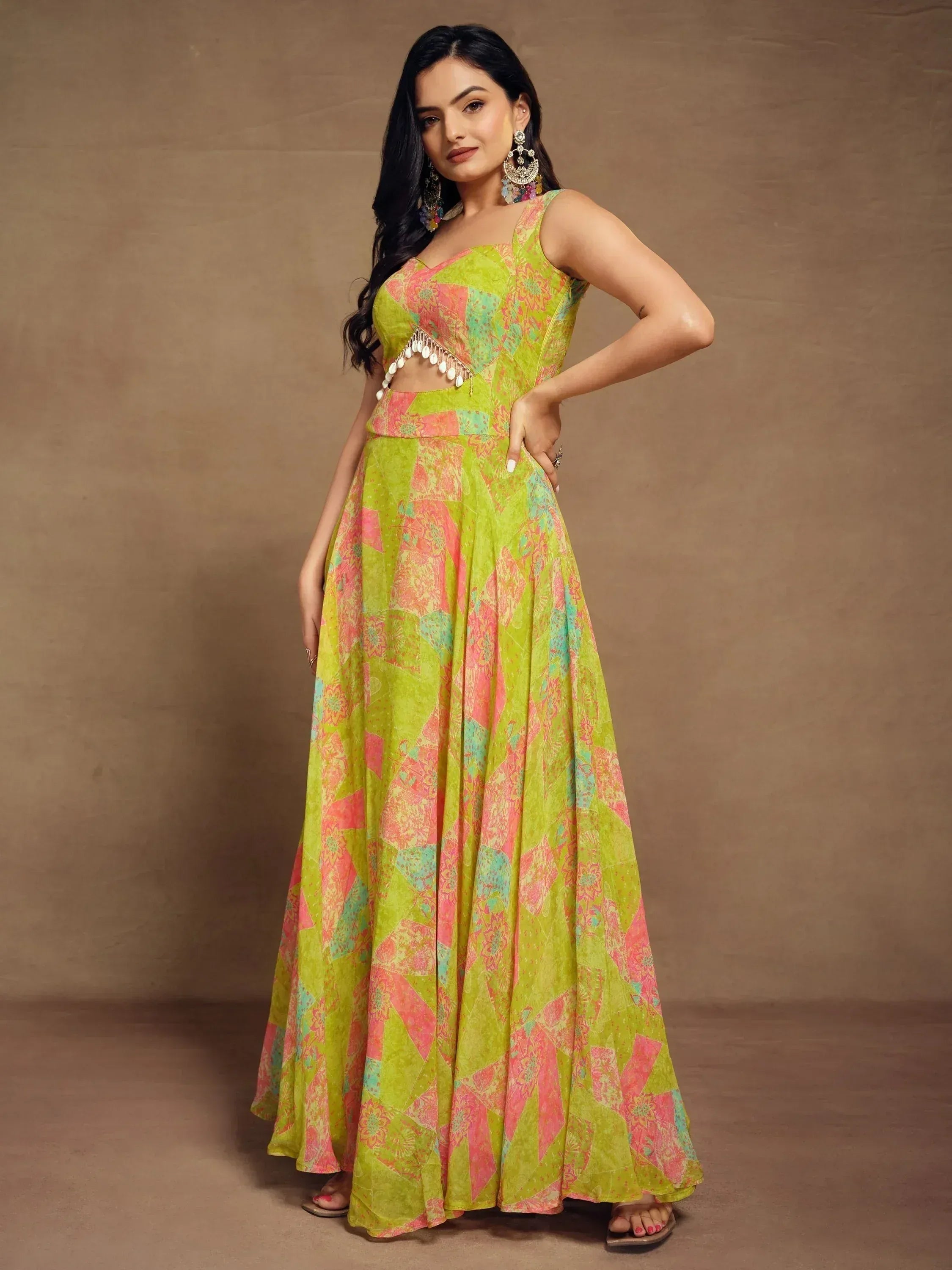 Vibrant green and pink printed ethnic gown with cut-out detail, perfect for Indian occasions.