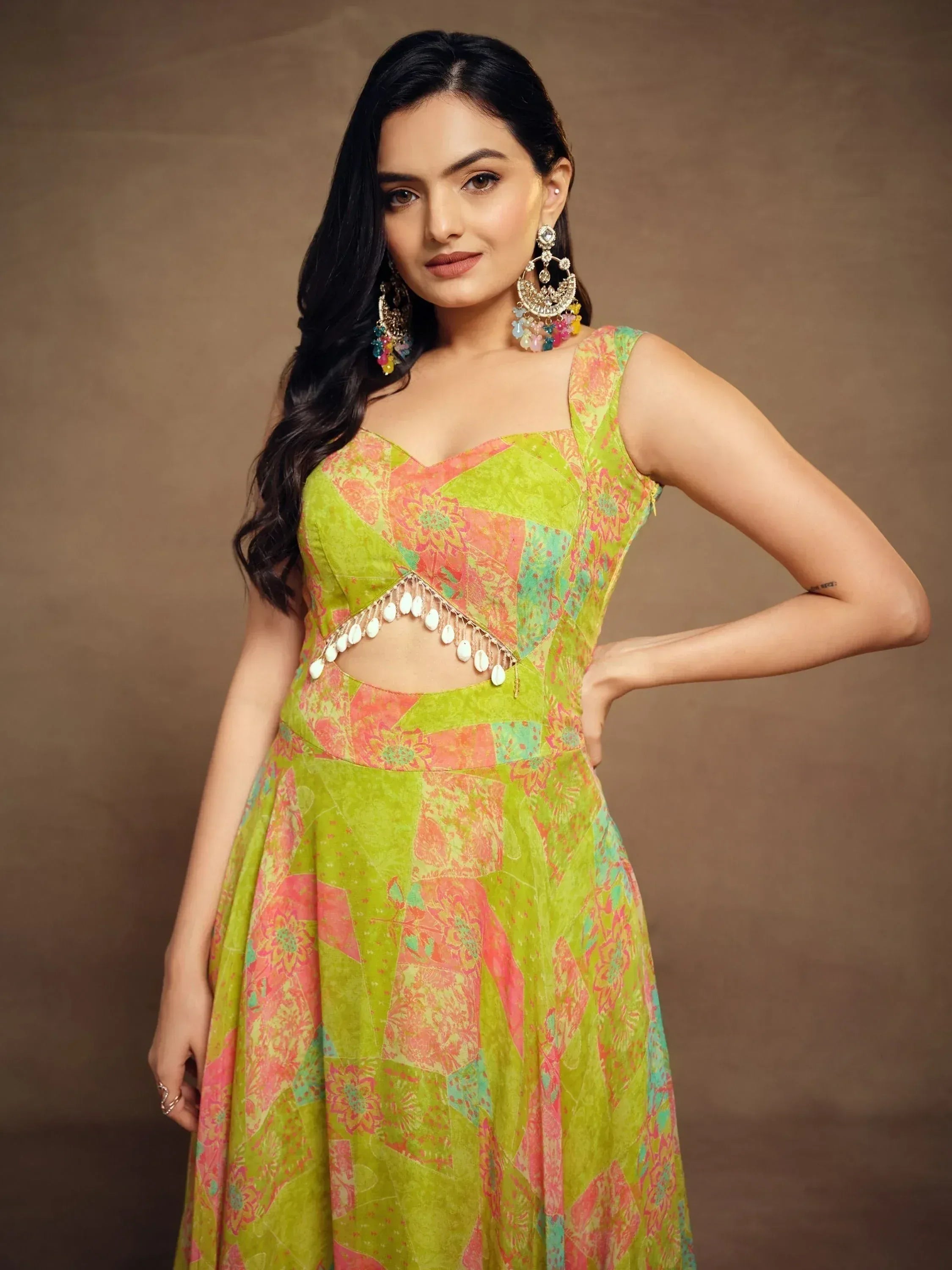 Vibrant green and pink printed ethnic gown with shell embellishments, perfect for festive occasions.