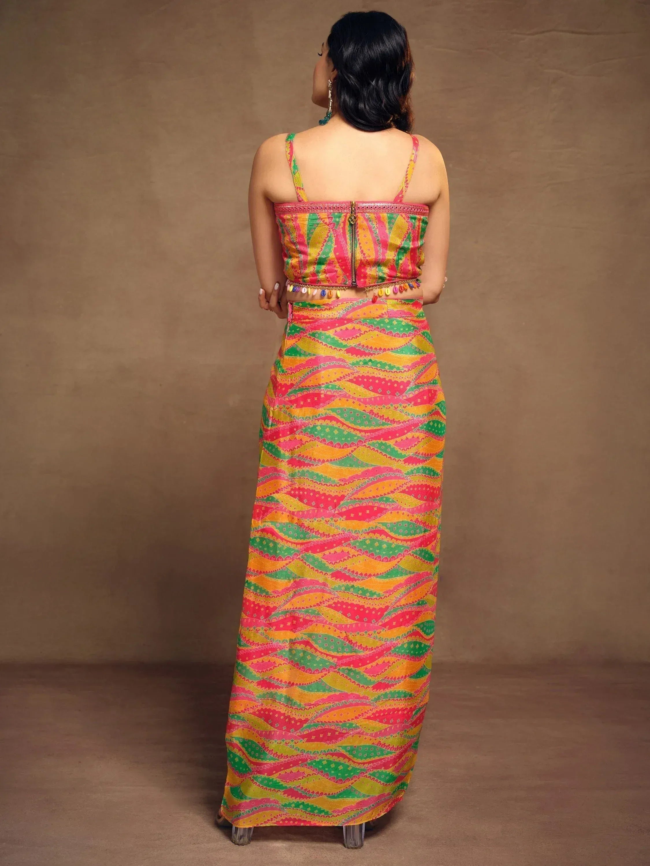 Vibrant multicolor ethnic gown with printed patterns and back zipper, perfect for Indian festive occasions.