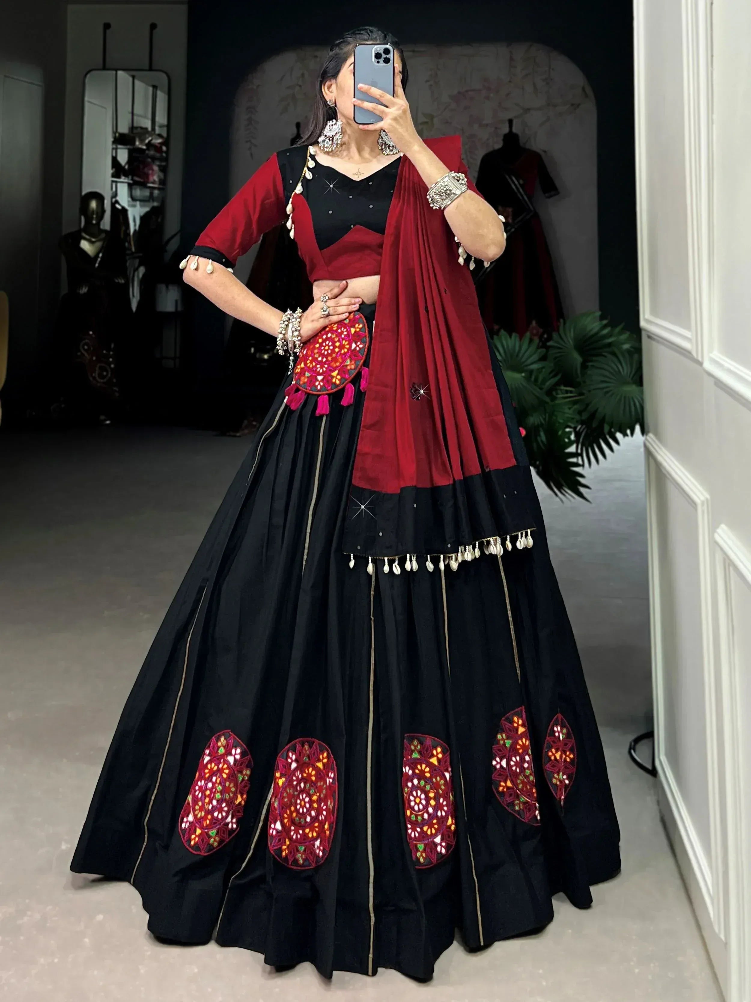 Black and maroon ethnic lehenga choli with mirror work, perfect for Indian weddings or festive occasions.