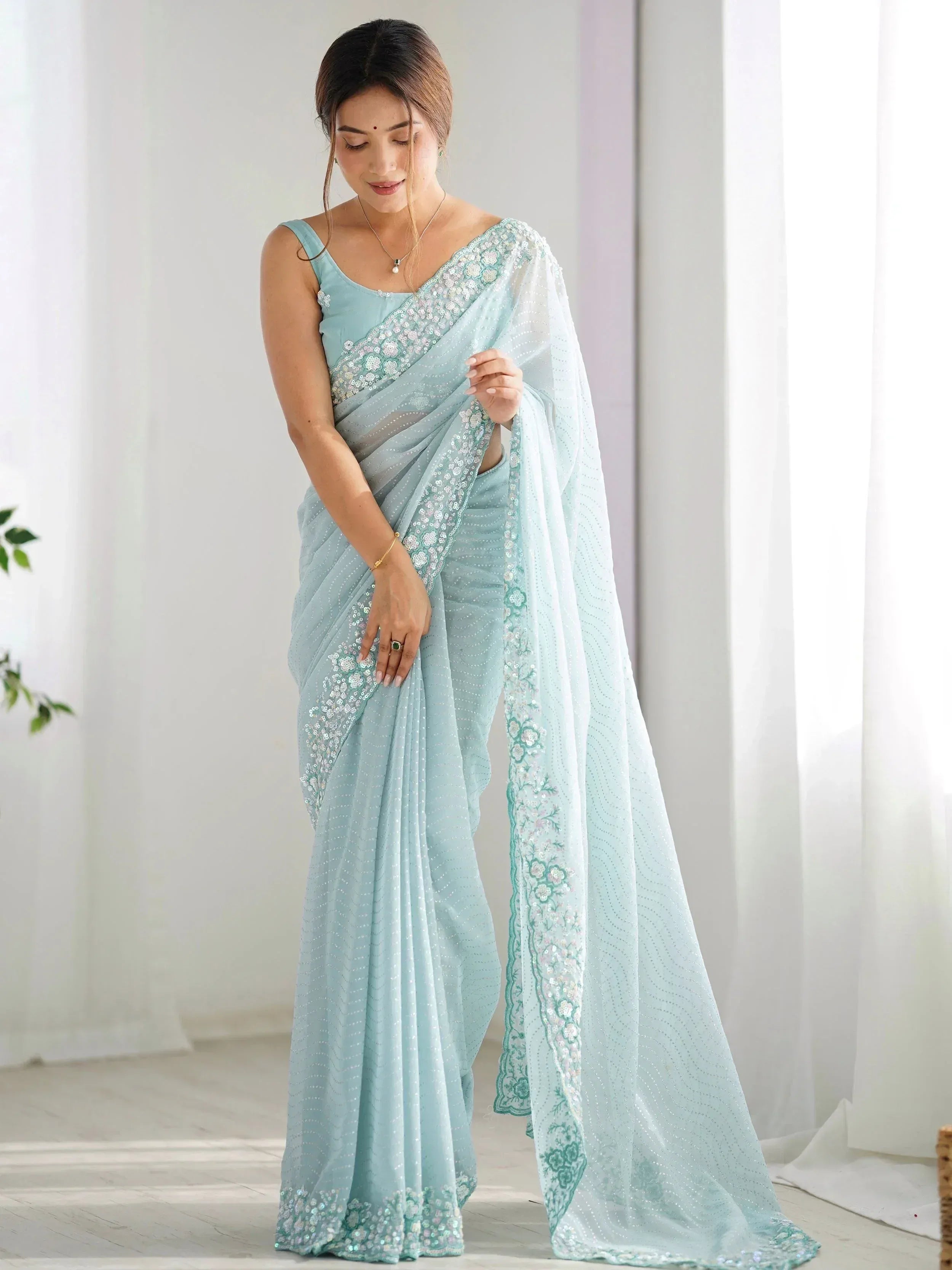 Light blue embroidered saree with sequin work, perfect for Indian ethnic occasions and festive wear.
