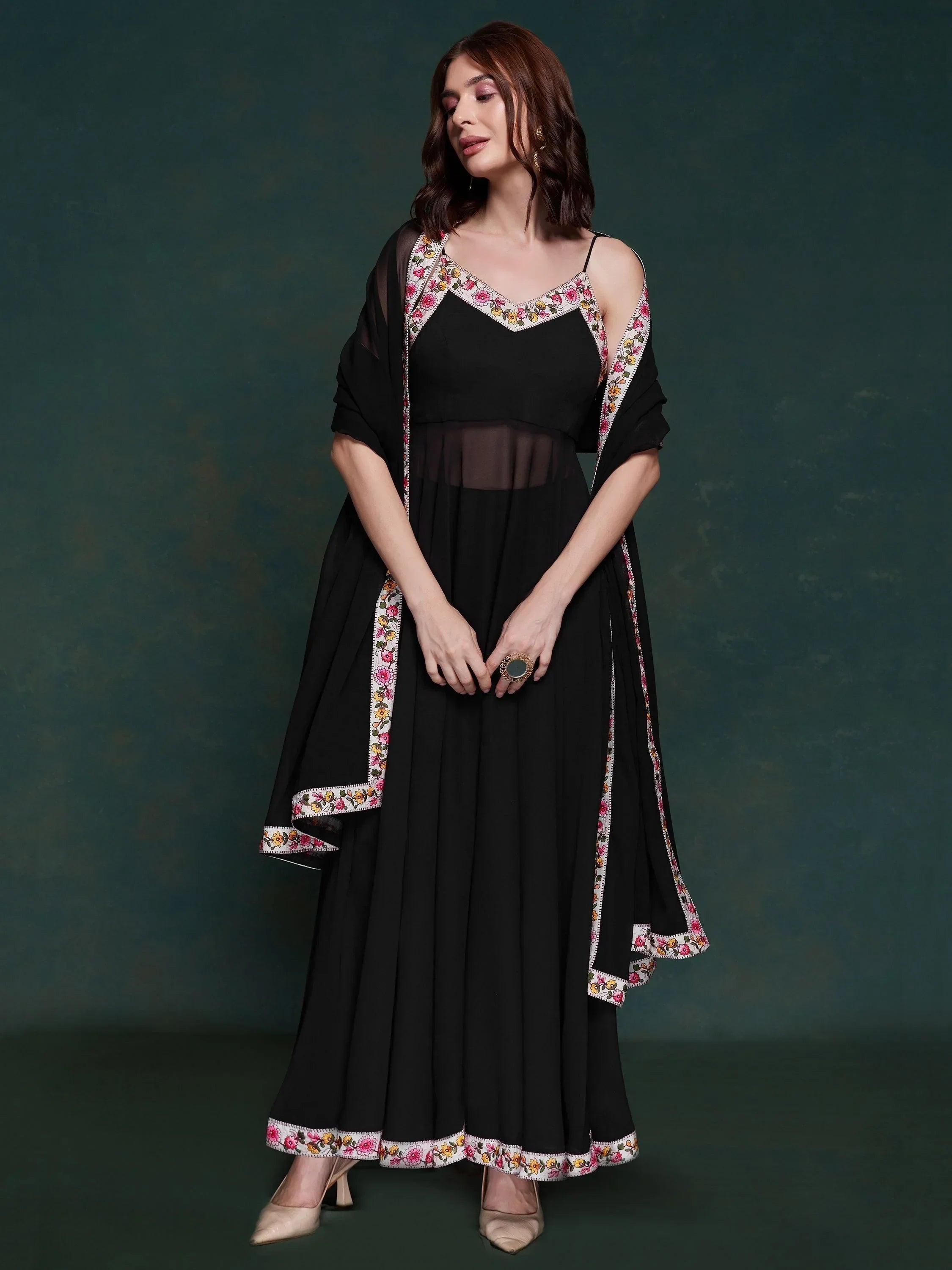 Woman in black ethnic gown with floral embroidered border and matching dupatta