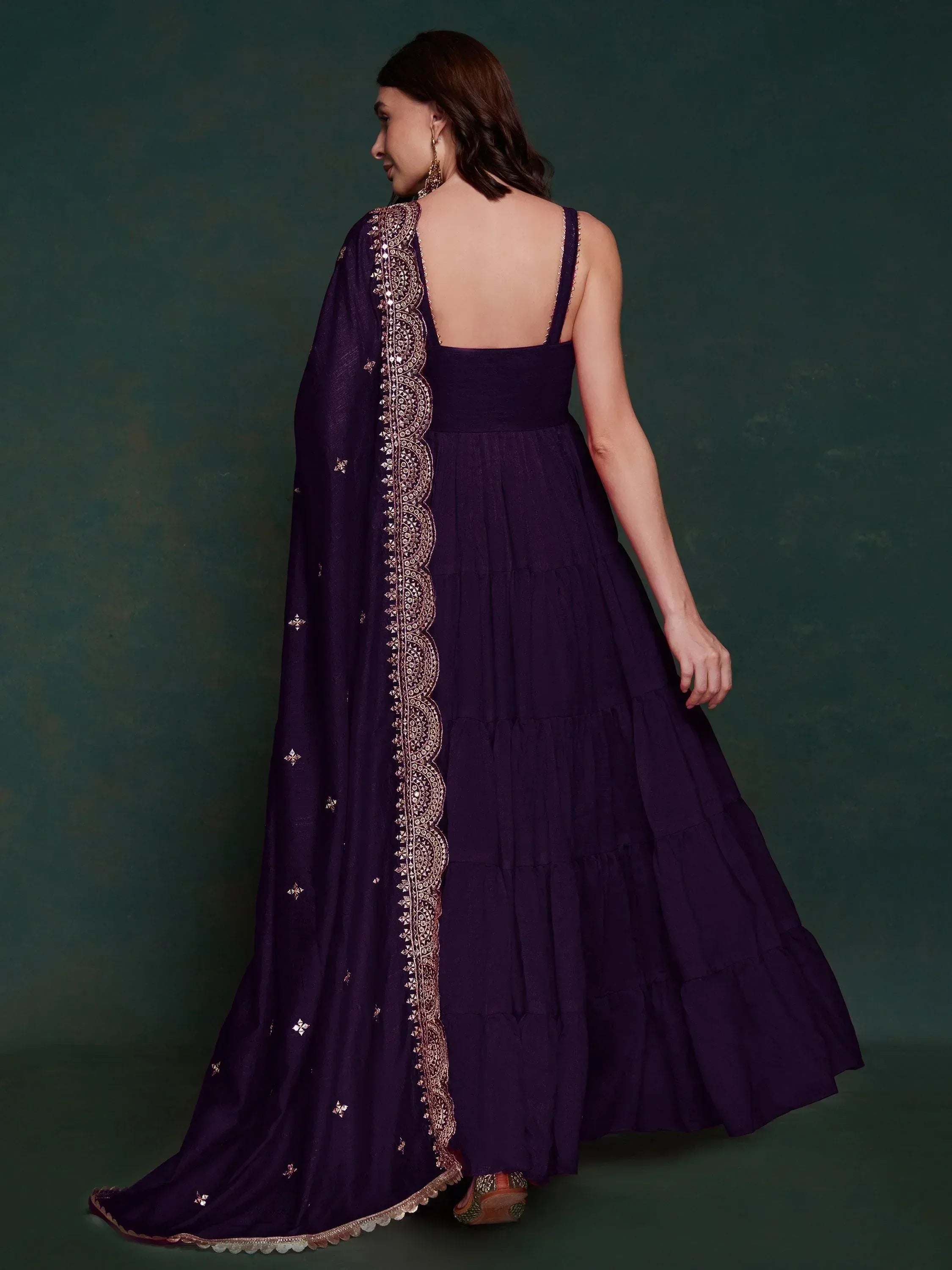 Purple ethnic gown with gold embroidery and layered skirt, back view