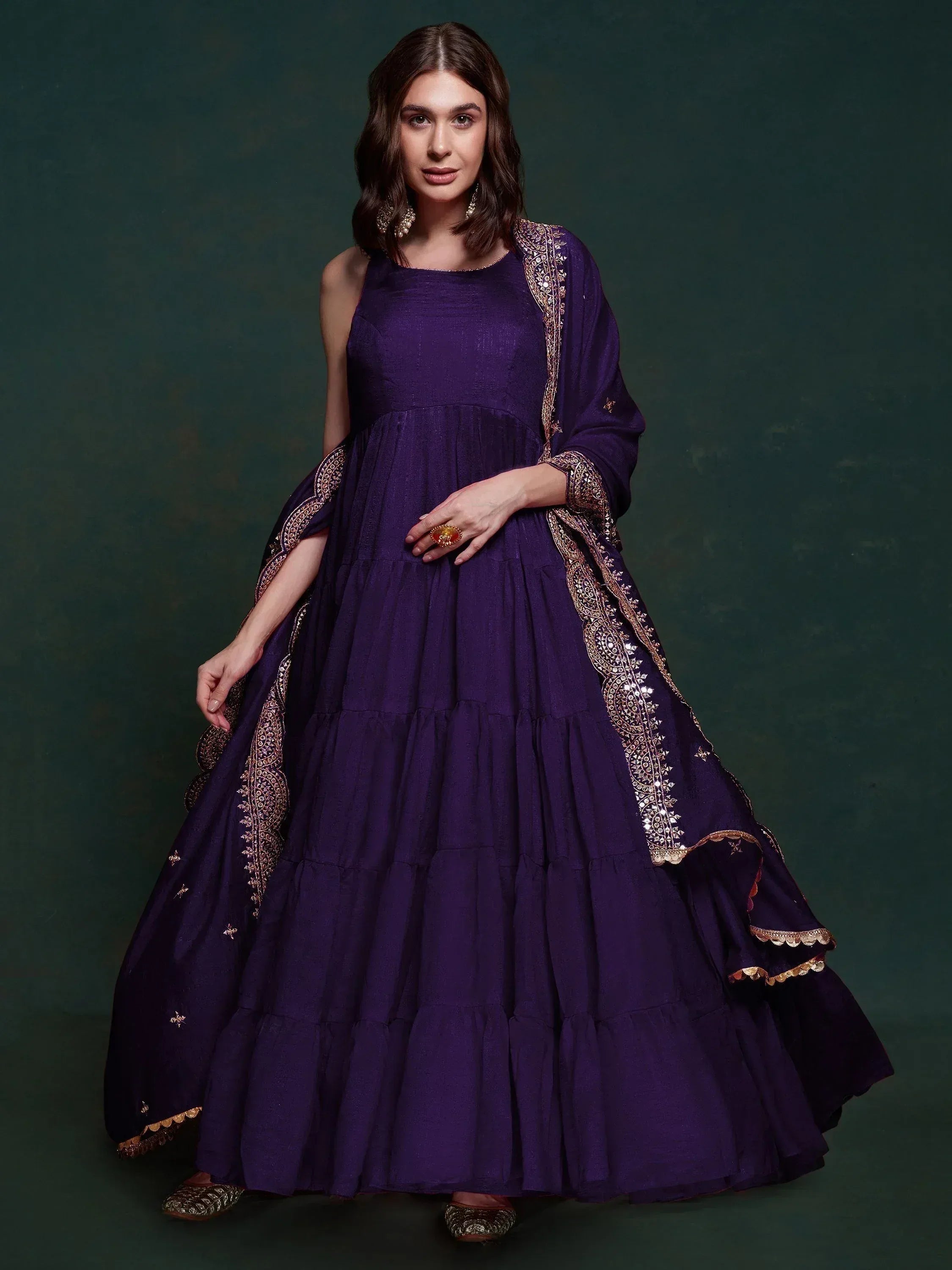 Purple tiered ethnic gown with gold embroidery and dupatta, perfect for Indian occasions