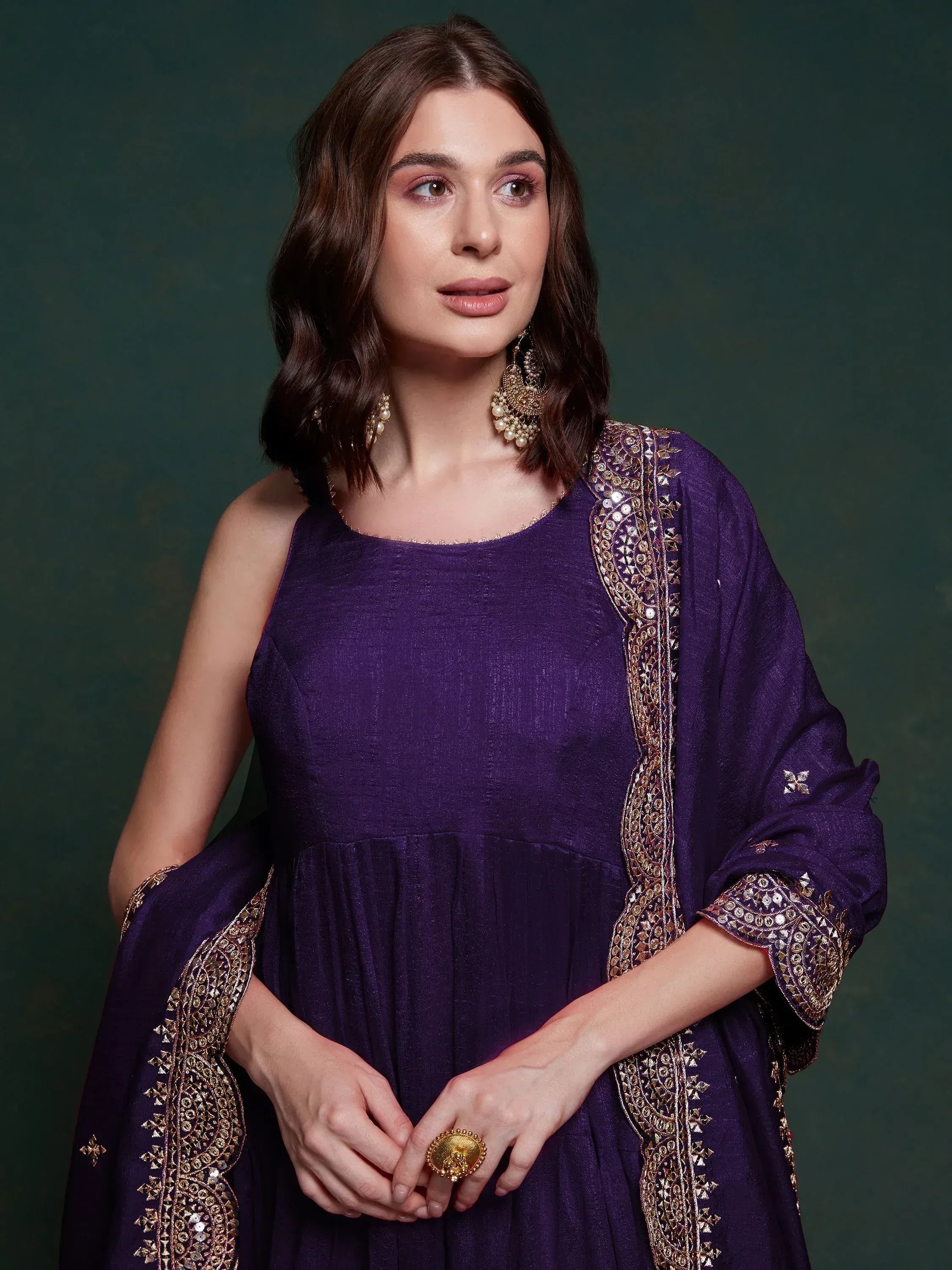 Purple ethnic gown with gold embroidery, perfect for Indian occasions and festive wear.