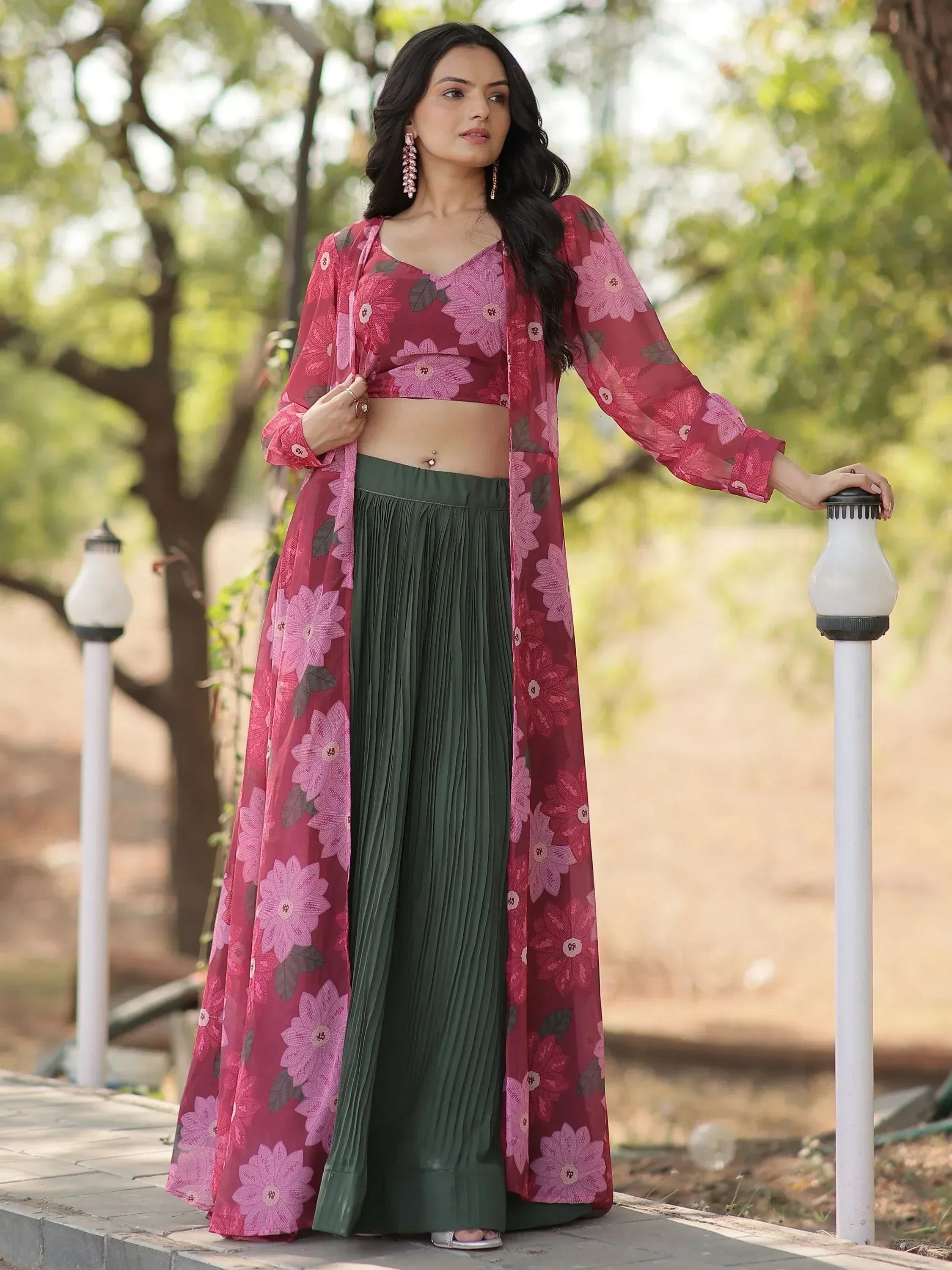 Woman in floral pink crop top, green pleated palazzo, and matching long shrug, styled for ethnic wear.
