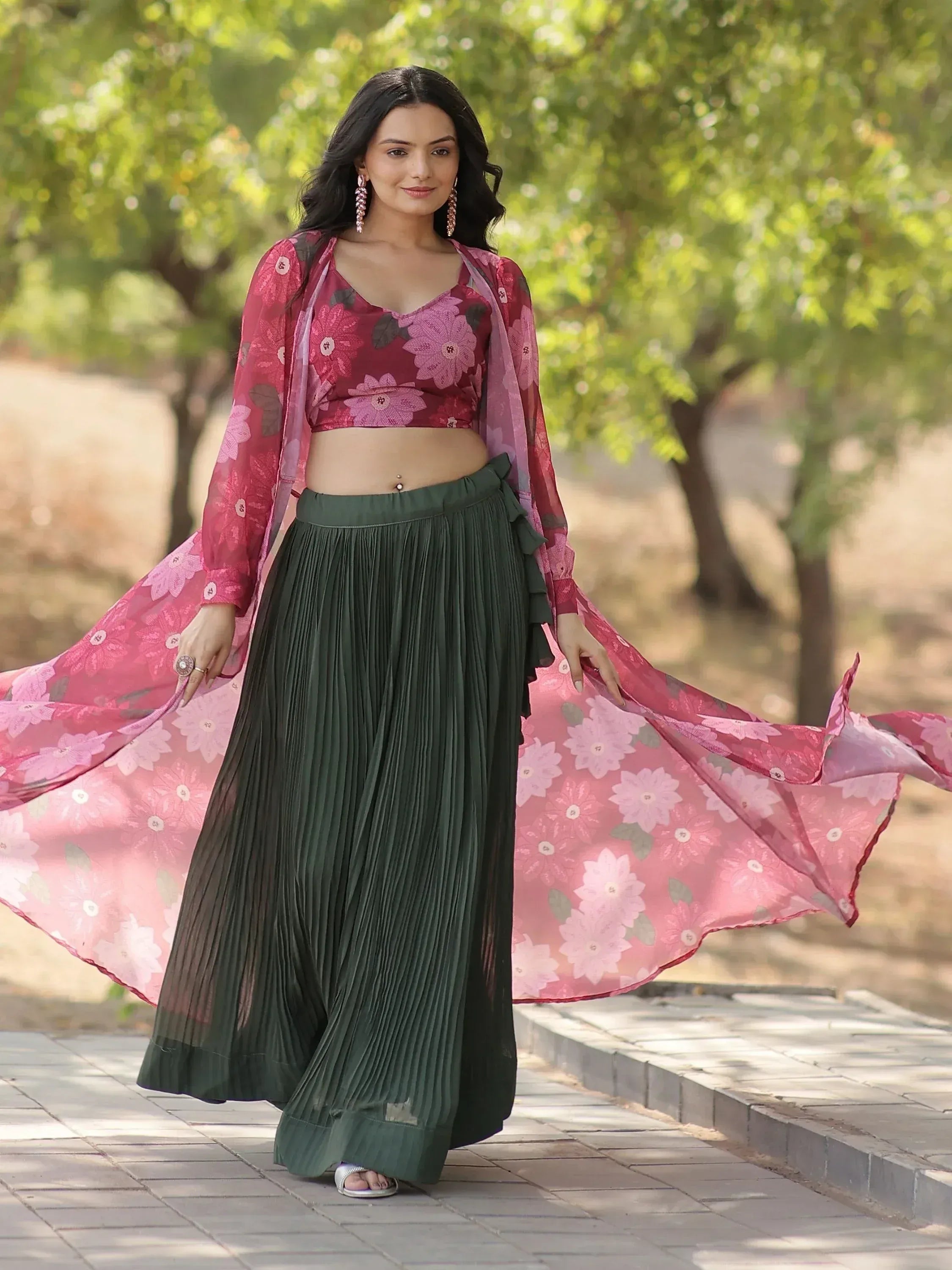 Woman in floral pink crop top with green pleated skirt and matching dupatta, ethnic wear outfit