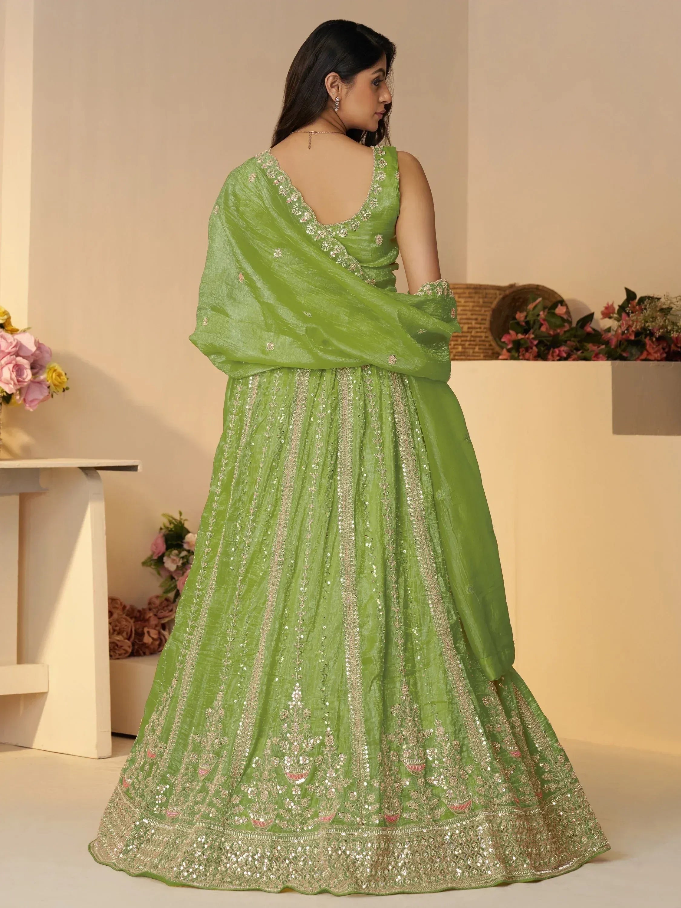 Green designer lehenga choli with floral embroidery and sequin work, perfect for Indian ethnic occasions