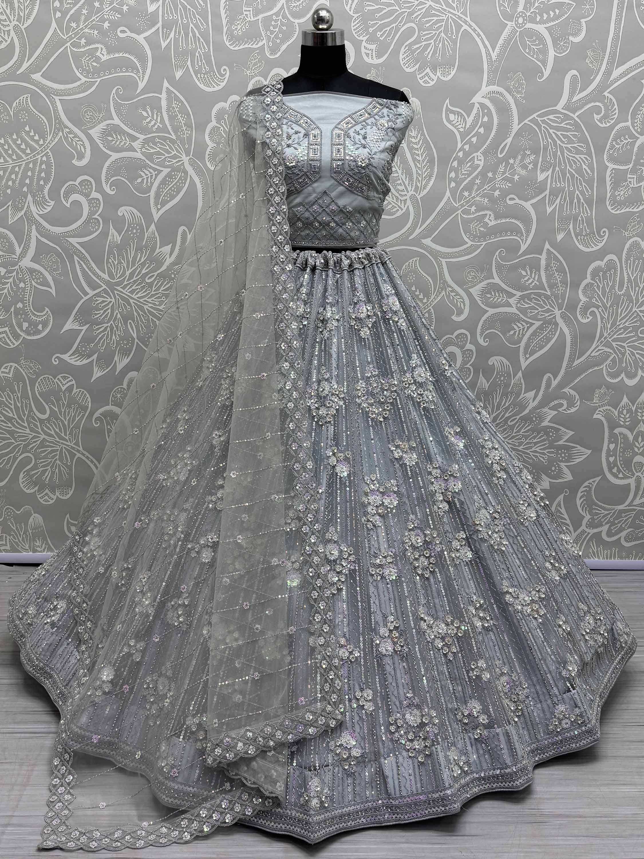 Elegant silver lehenga choli with intricate embroidery and sequin work, perfect for weddings and festive occasions.