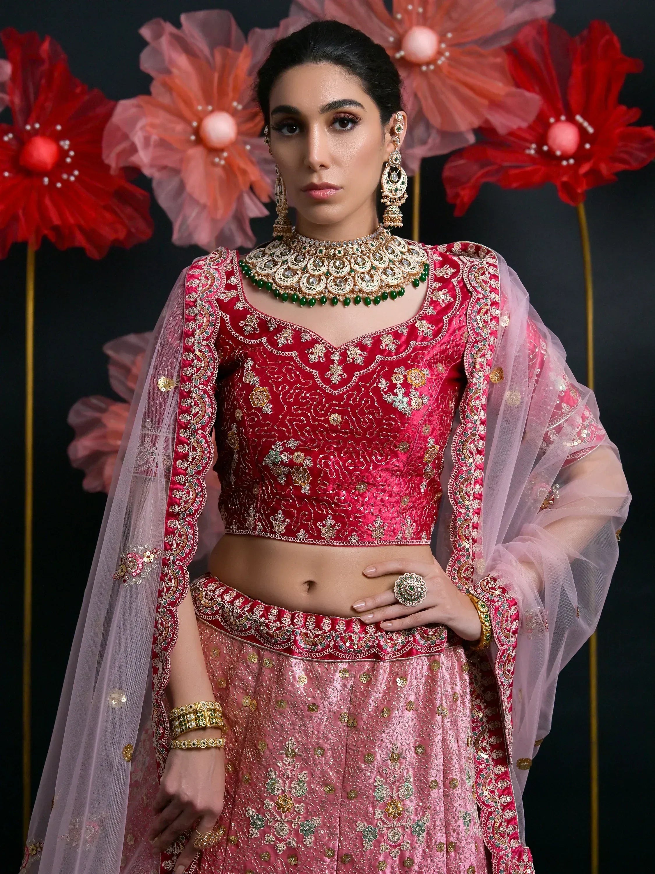 Pink and red embroidered lehenga choli with sheer dupatta, perfect for Indian weddings and festive occasions.