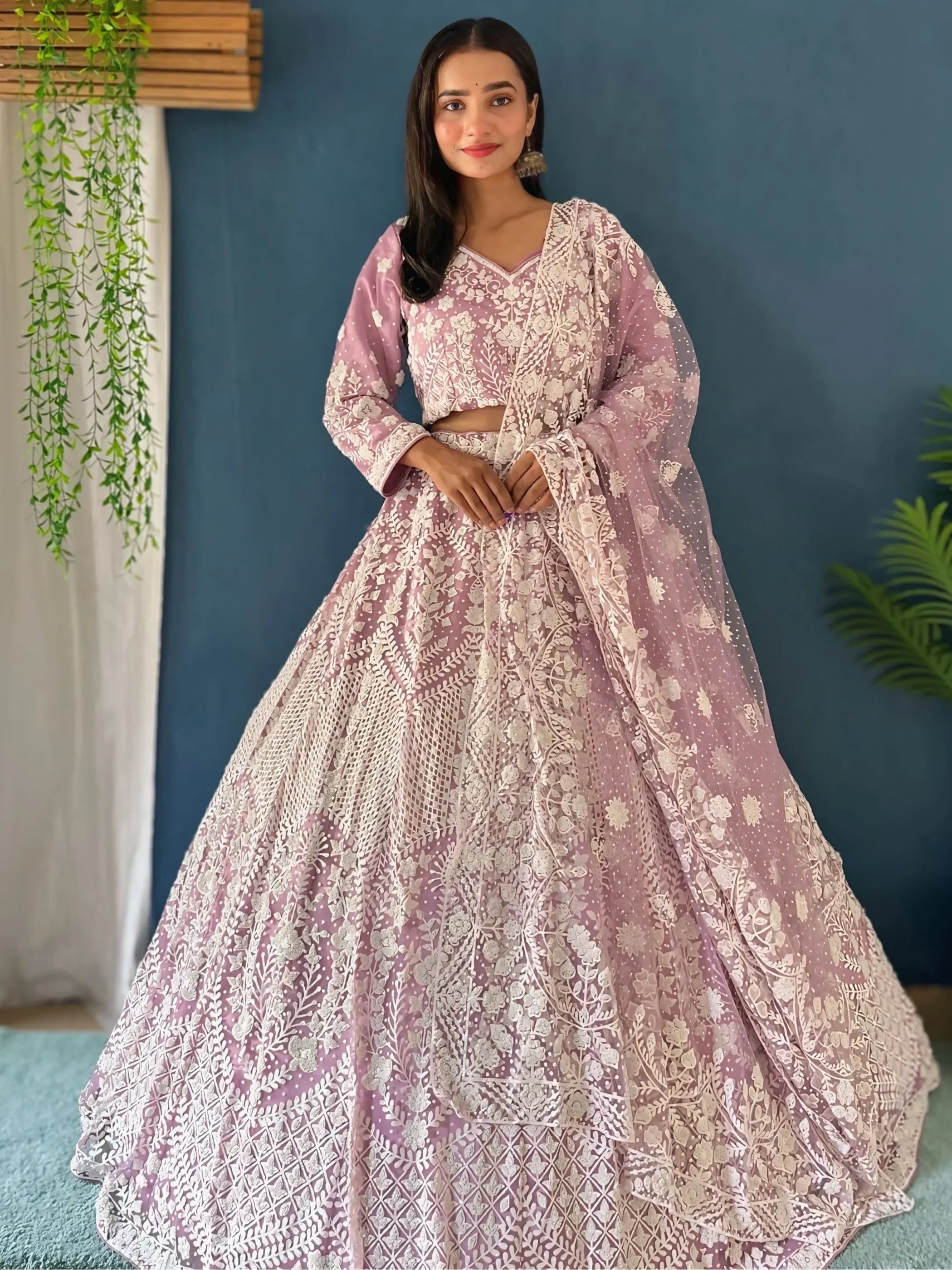 Elegant pink lehenga choli with white floral embroidery, perfect for Indian weddings and festive occasions.