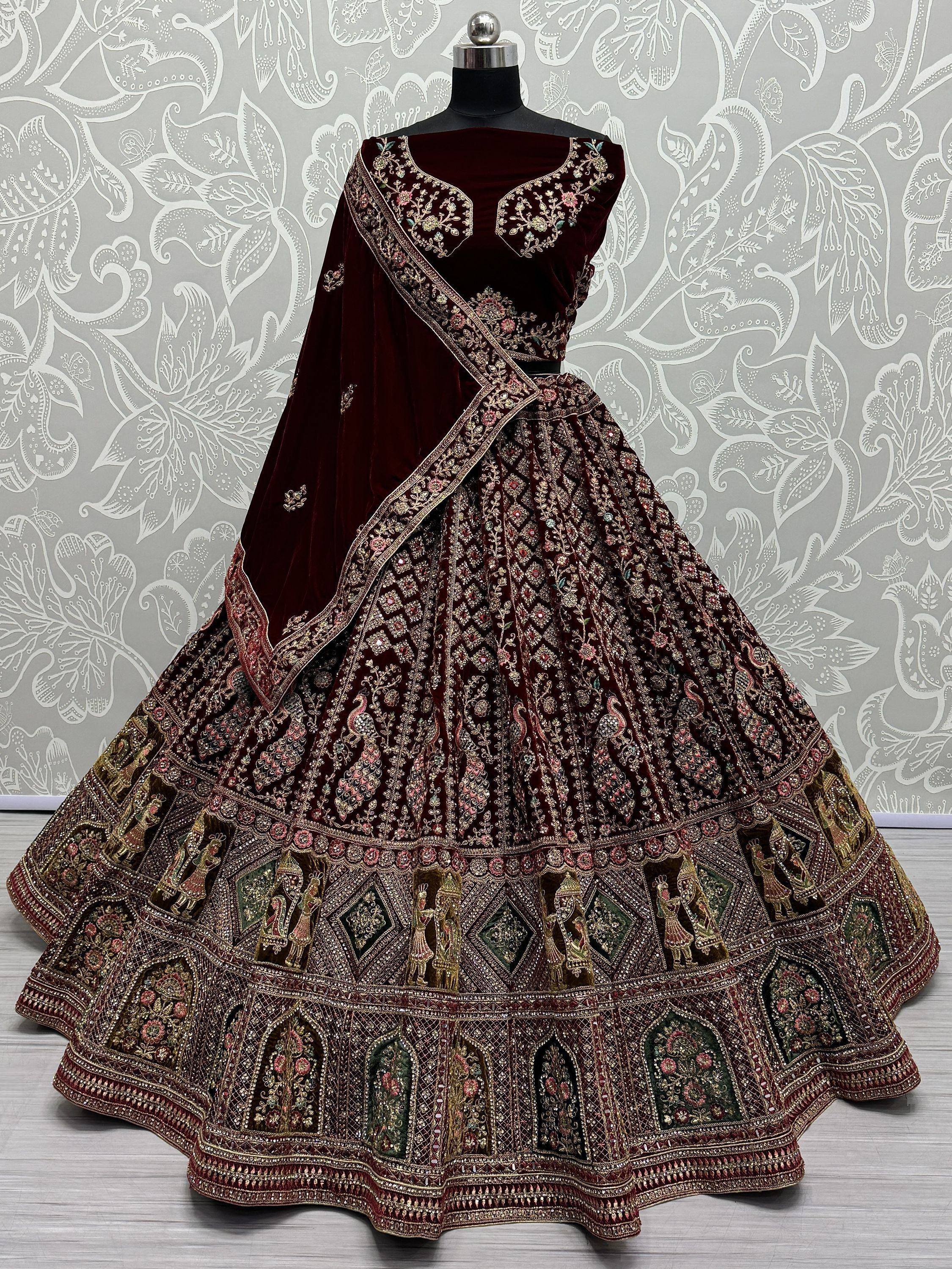 Maroon velvet designer lehenga choli with heavy embroidery and peacock motifs, perfect for weddings