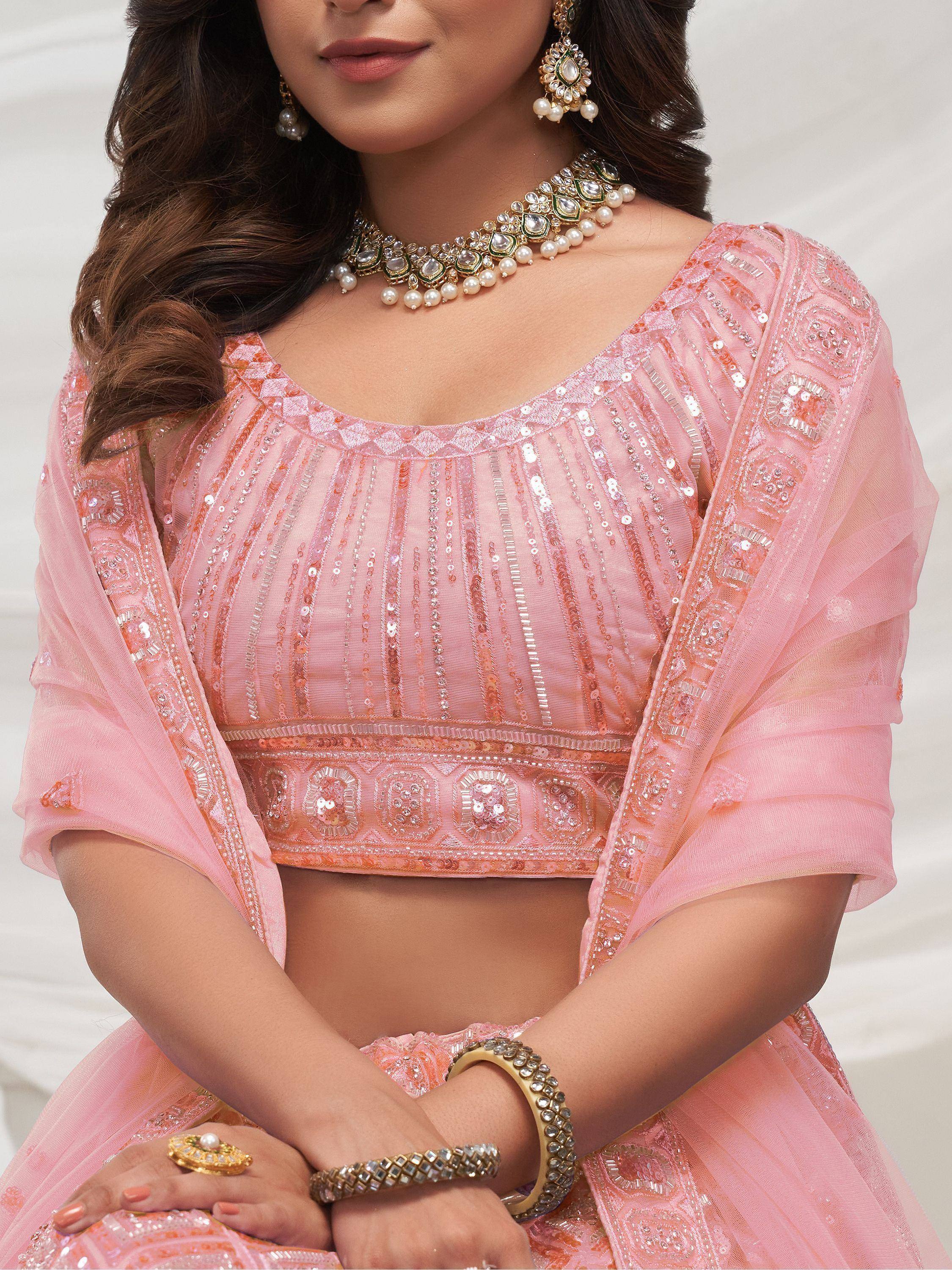 Pink sequined lehenga choli with pearl jewelry, perfect for Indian ethnic wear and festive occasions.