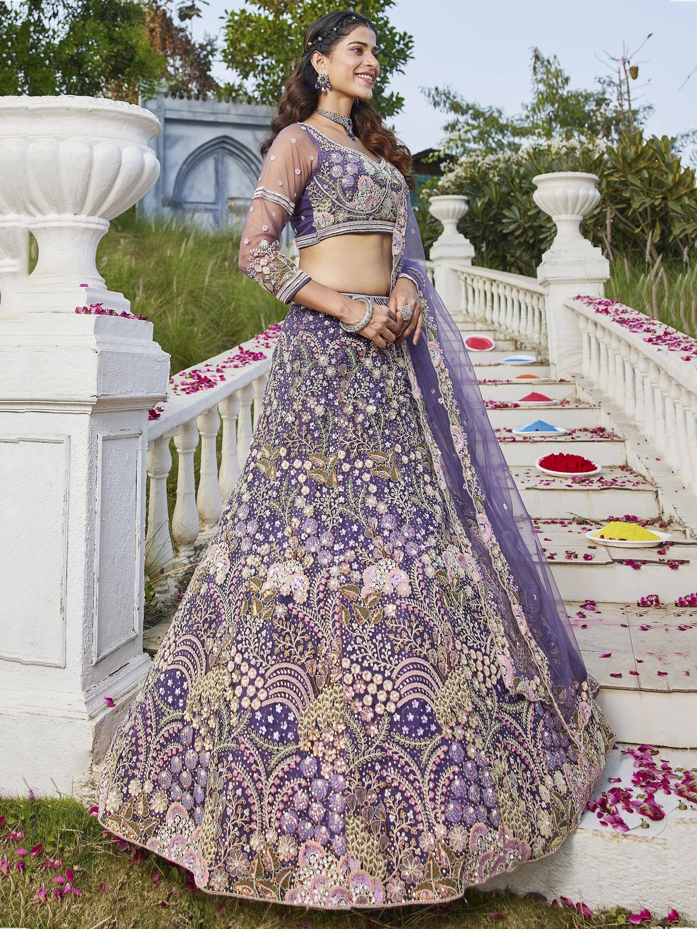 Purple embroidered lehenga choli with floral motifs, perfect for Indian weddings and festive occasions
