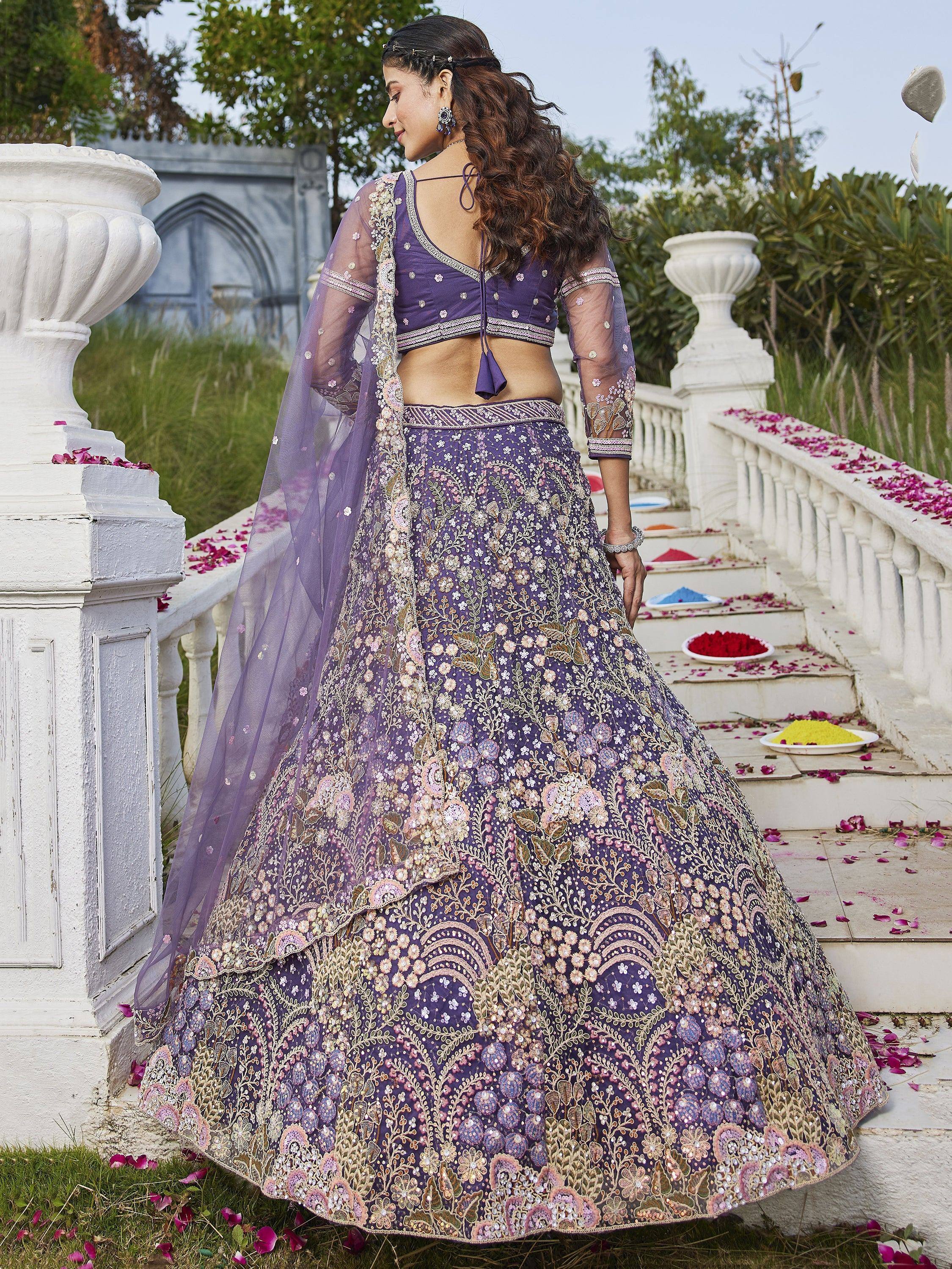 Purple embroidered lehenga choli with floral motifs, perfect for Indian weddings and festive occasions.
