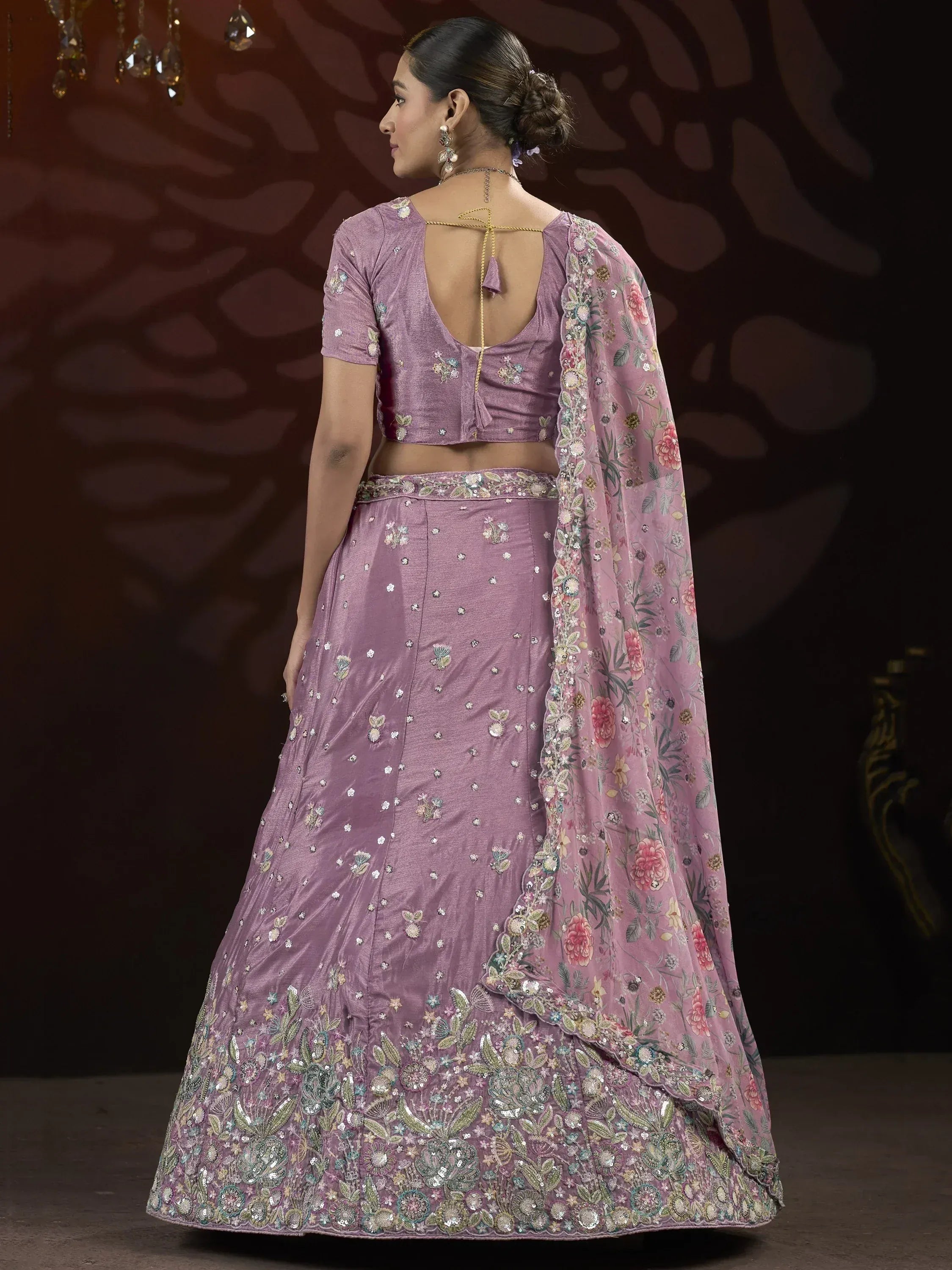 Purple embroidered lehenga choli with floral dupatta, back view
