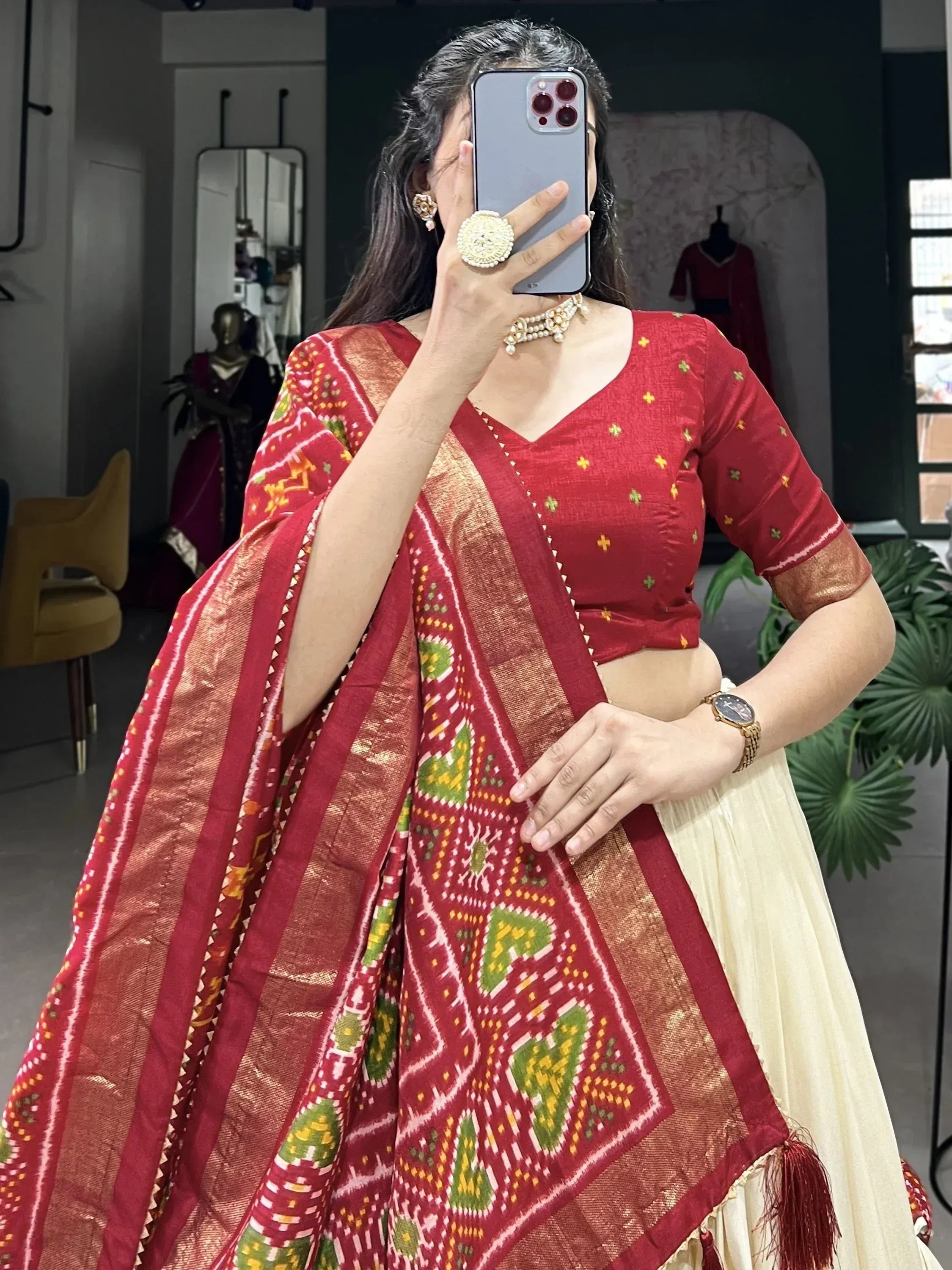 Woman in red embroidered lehenga choli with ikat dupatta, Indian ethnic wear