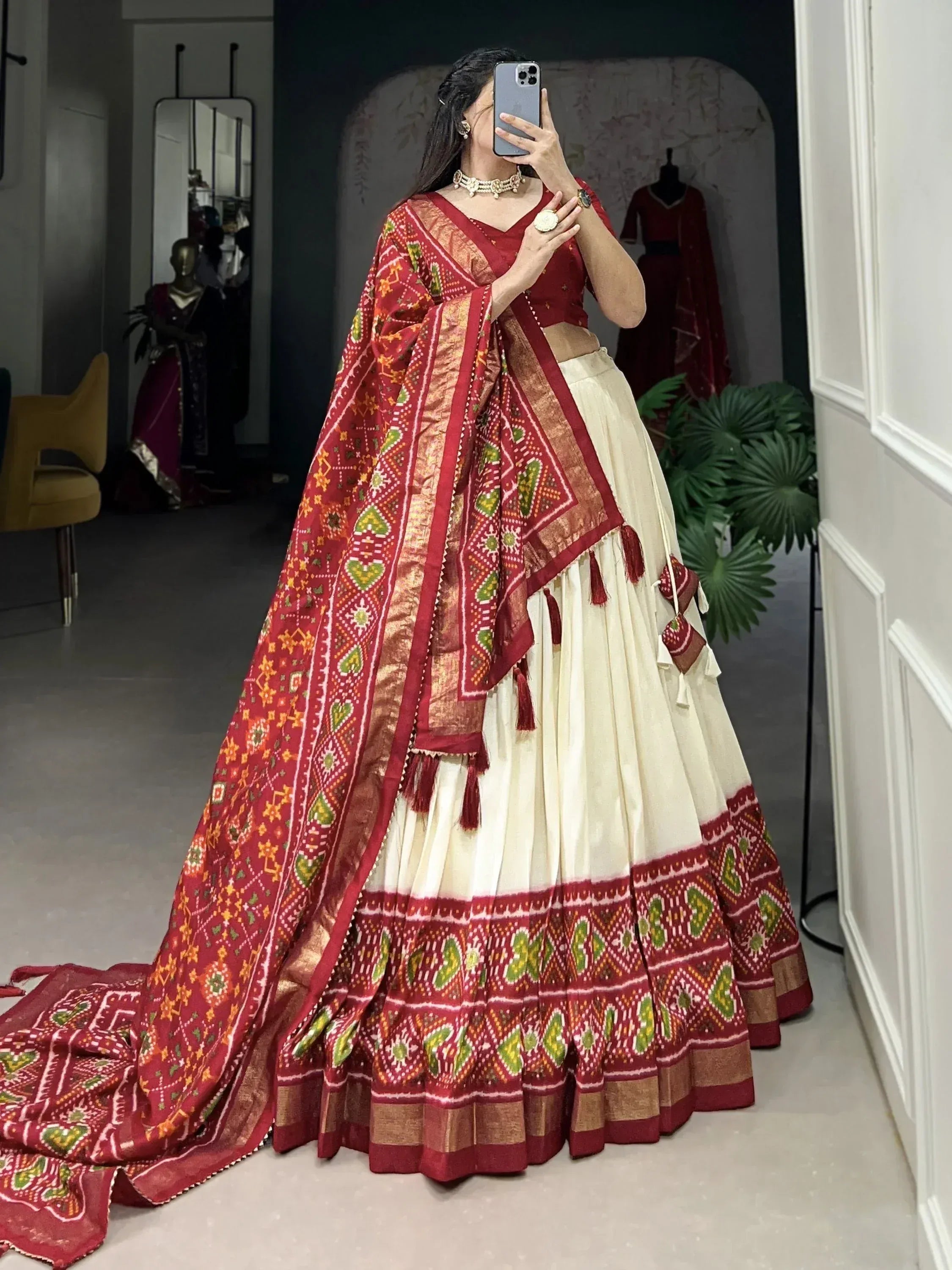 Red and cream ethnic lehenga choli with printed dupatta, perfect for Indian weddings and festive occasions.