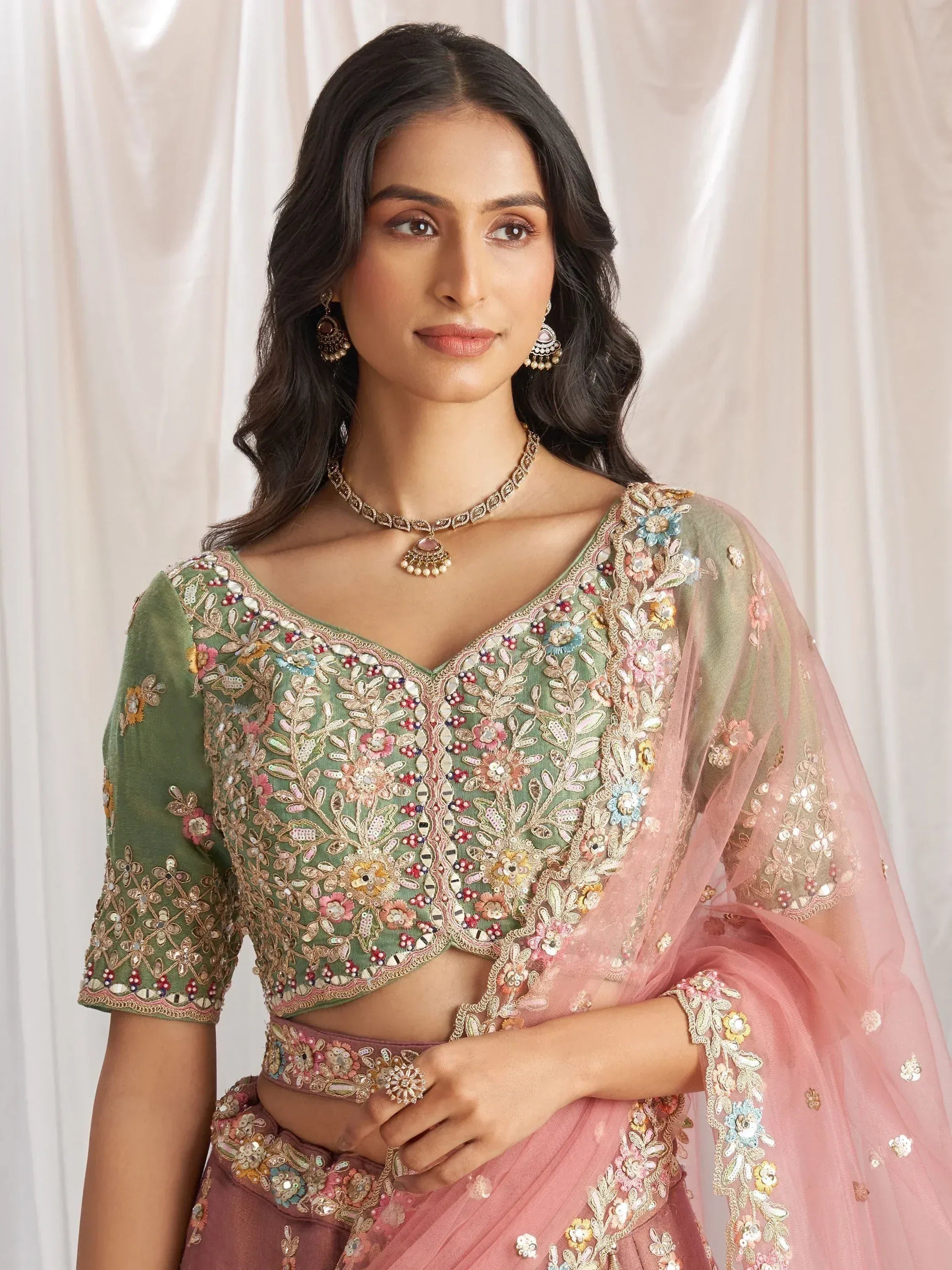 Green and pink embroidered lehenga choli with floral detailing, perfect for Indian ethnic wear occasions