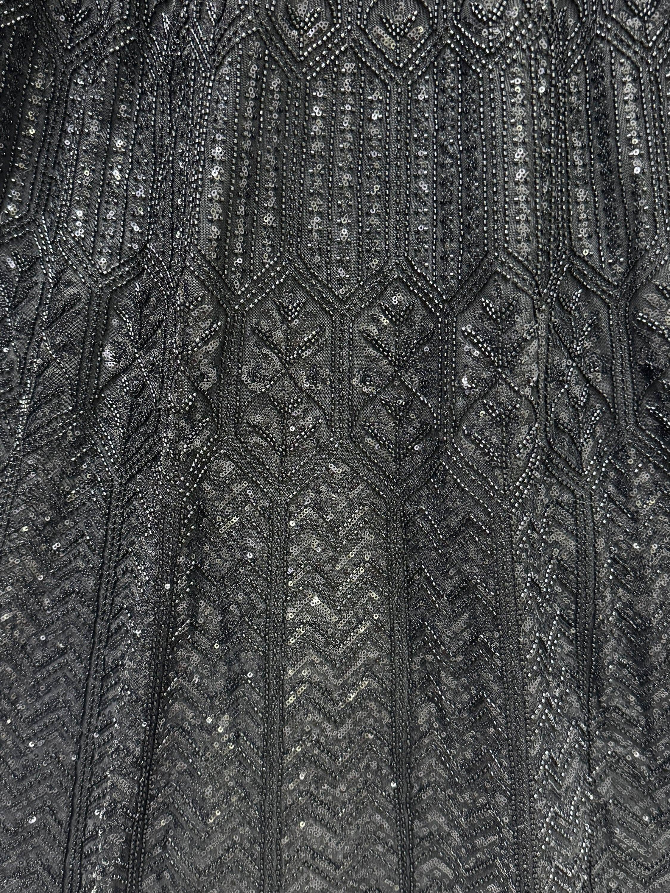 Black ethnic wear fabric with intricate silver sequin and bead embroidery pattern