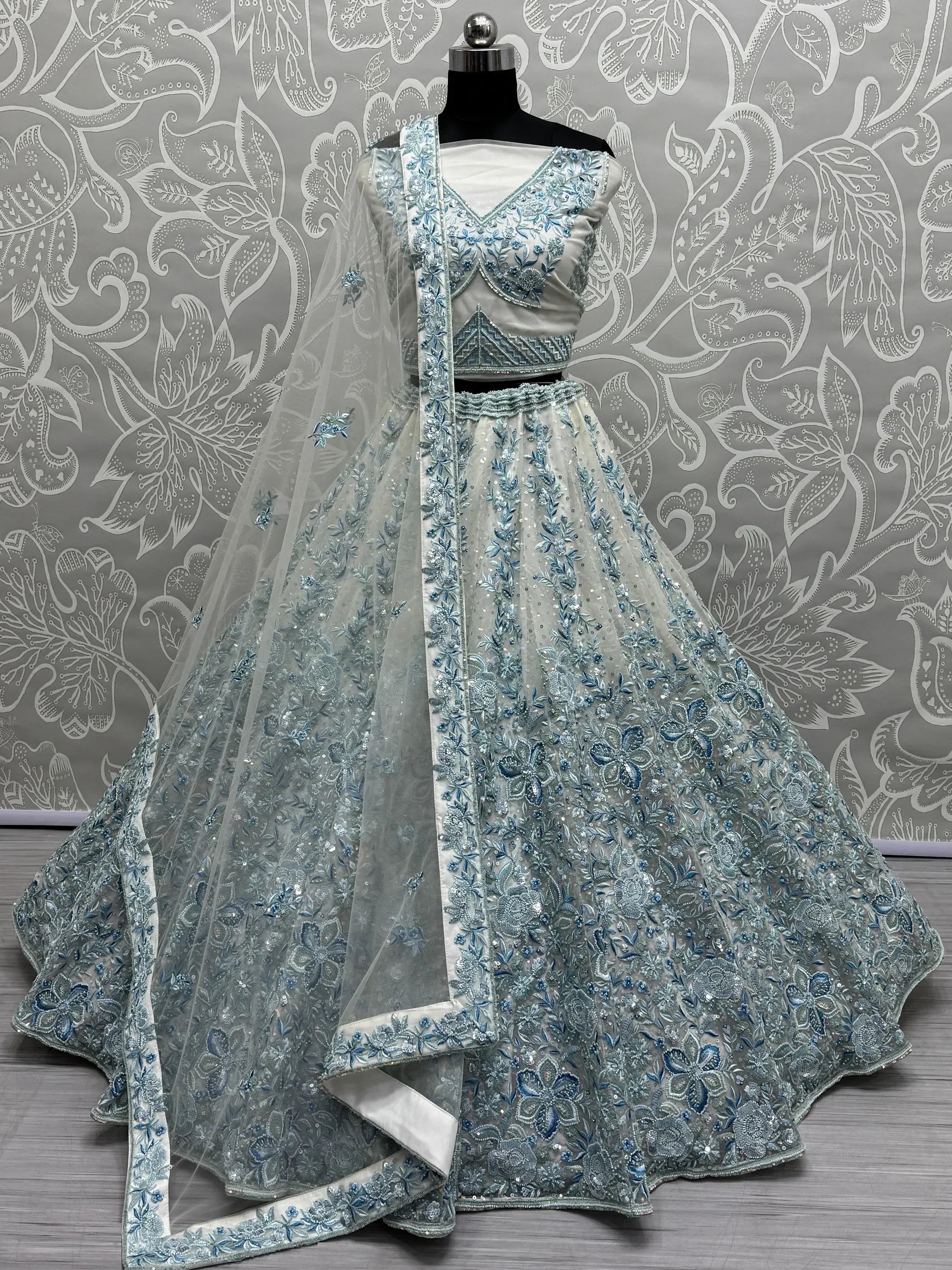 Elegant silver and blue embroidered lehenga choli with floral detailing, perfect for Indian ethnic occasions.