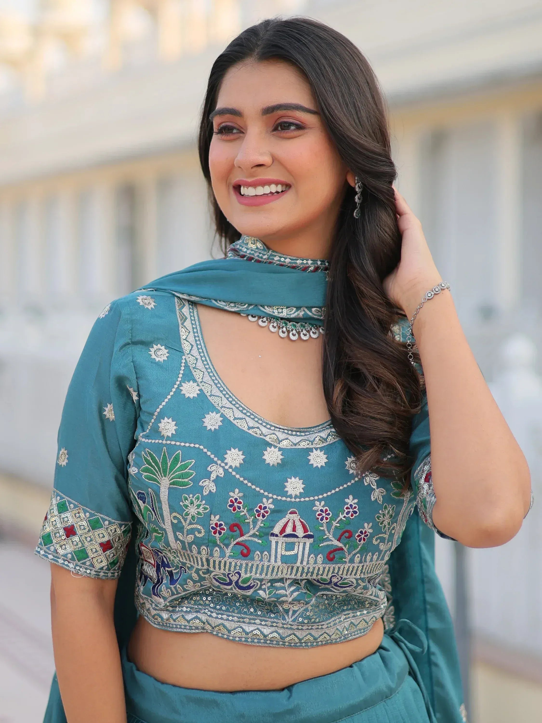 Teal embroidered Indian ethnic wear with floral and elephant motifs, perfect for festive occasions.