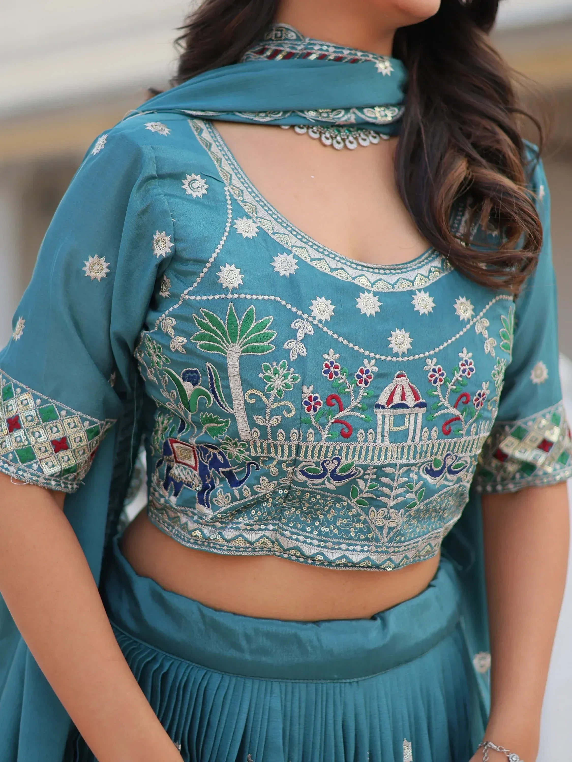 Teal embroidered lehenga choli with floral and elephant motifs, perfect for Indian ethnic wear