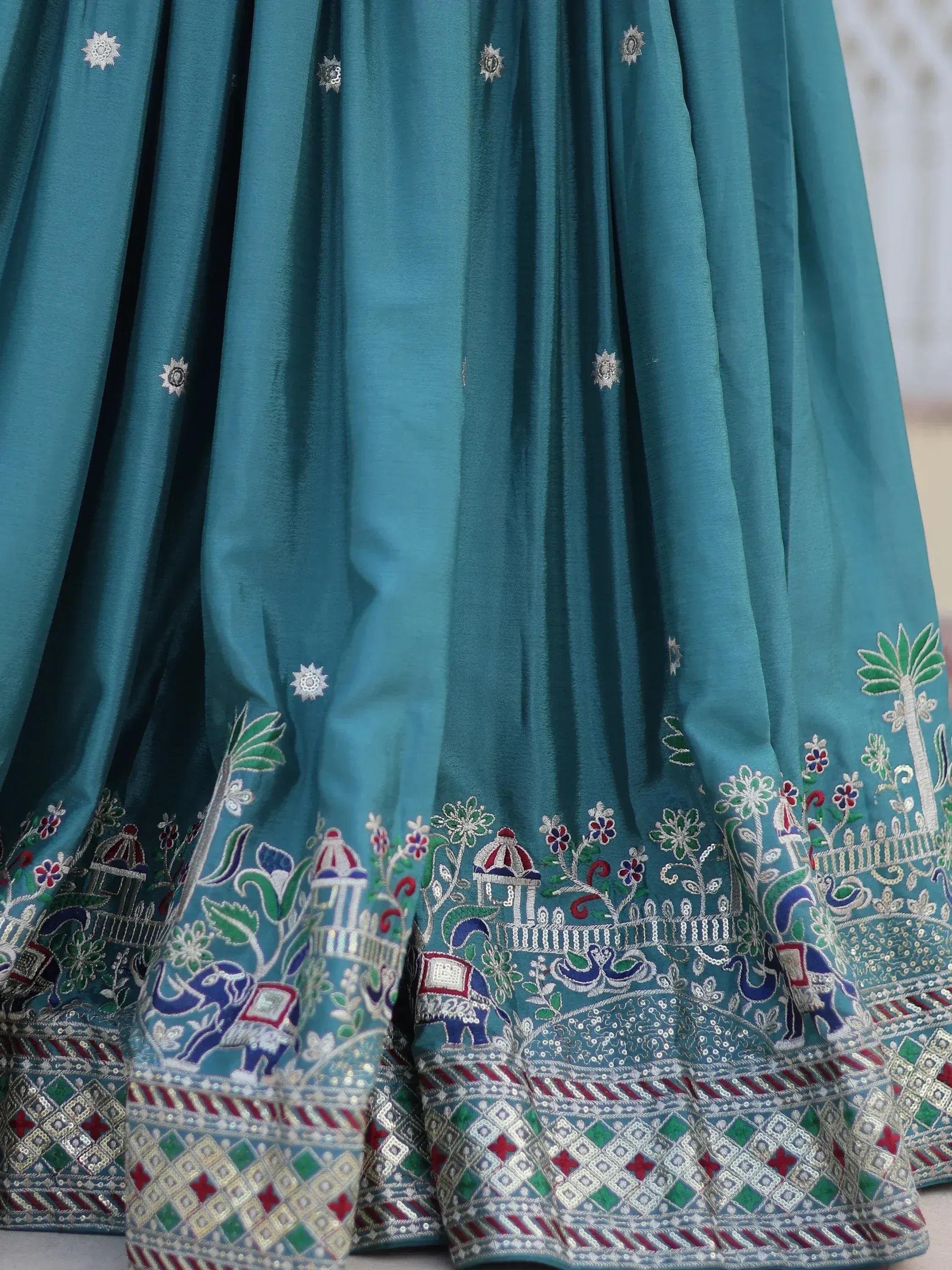 Teal lehenga skirt with intricate elephant and floral embroidery, perfect for Indian ethnic wear.