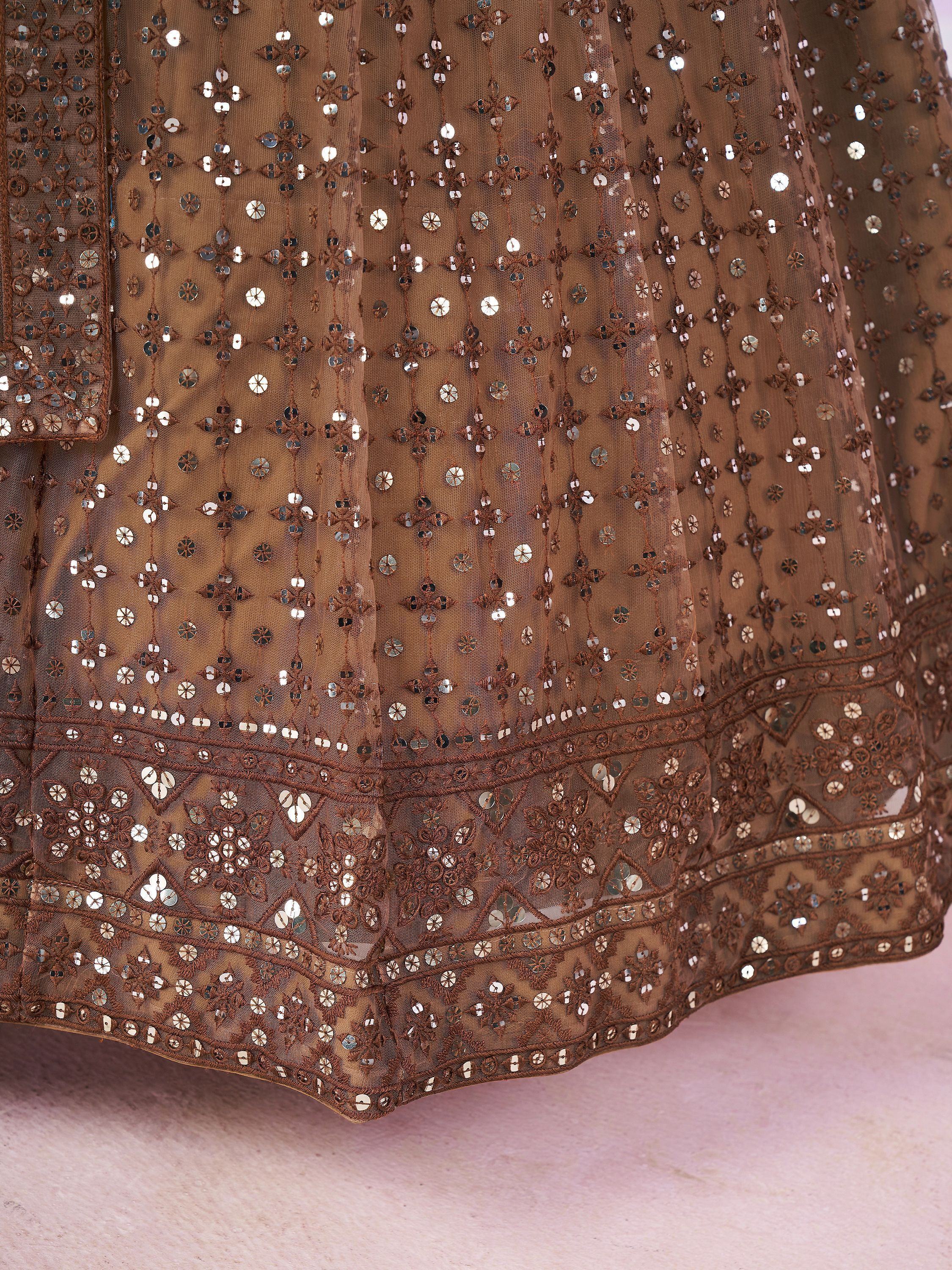 Brown ethnic gown with intricate sequin and mirror work, perfect for Indian celebrations