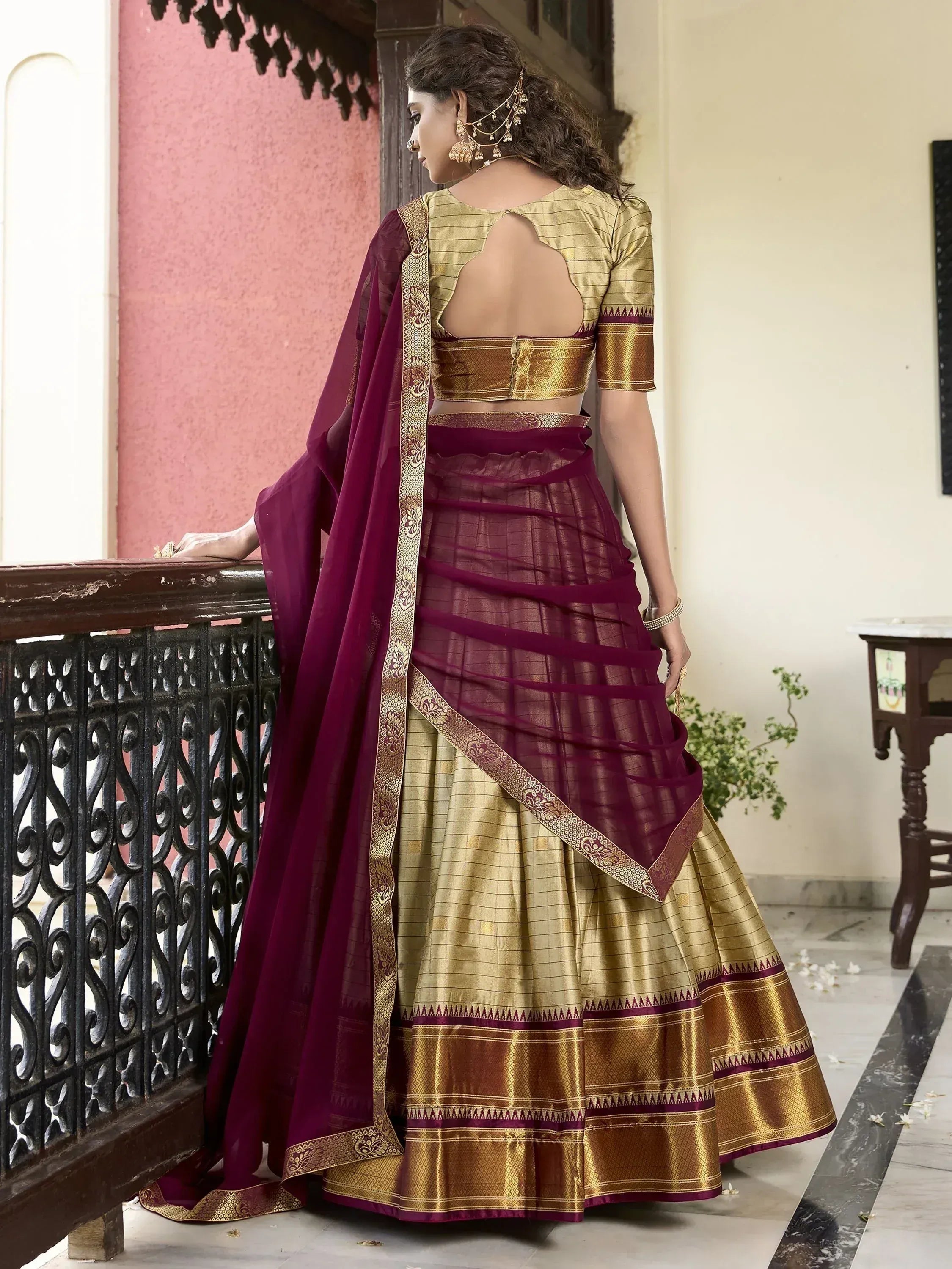 Elegant maroon and gold lehenga choli with backless blouse, perfect for Indian ethnic occasions
