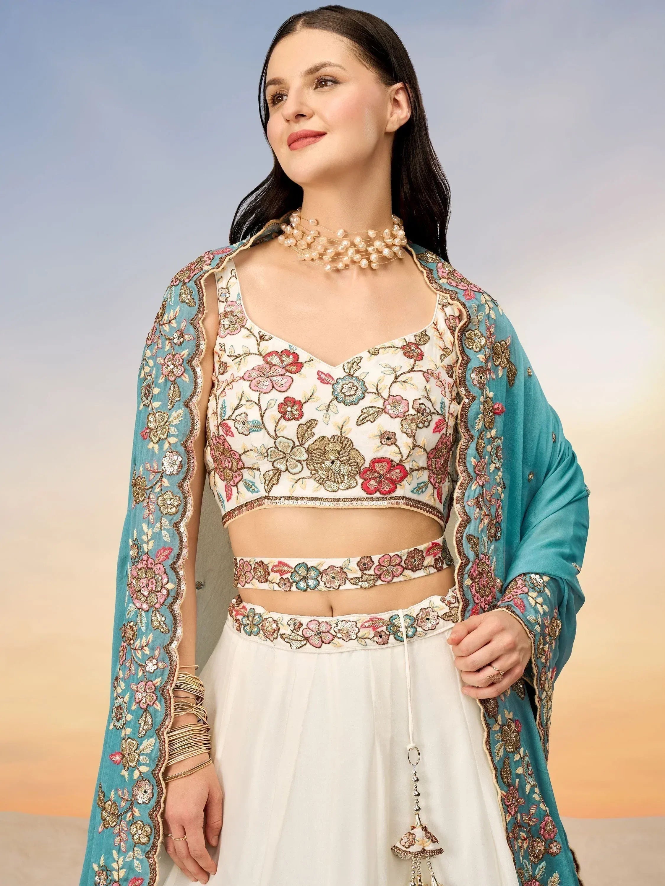Floral embroidered white lehenga choli with teal dupatta, perfect for Indian ethnic wear occasions