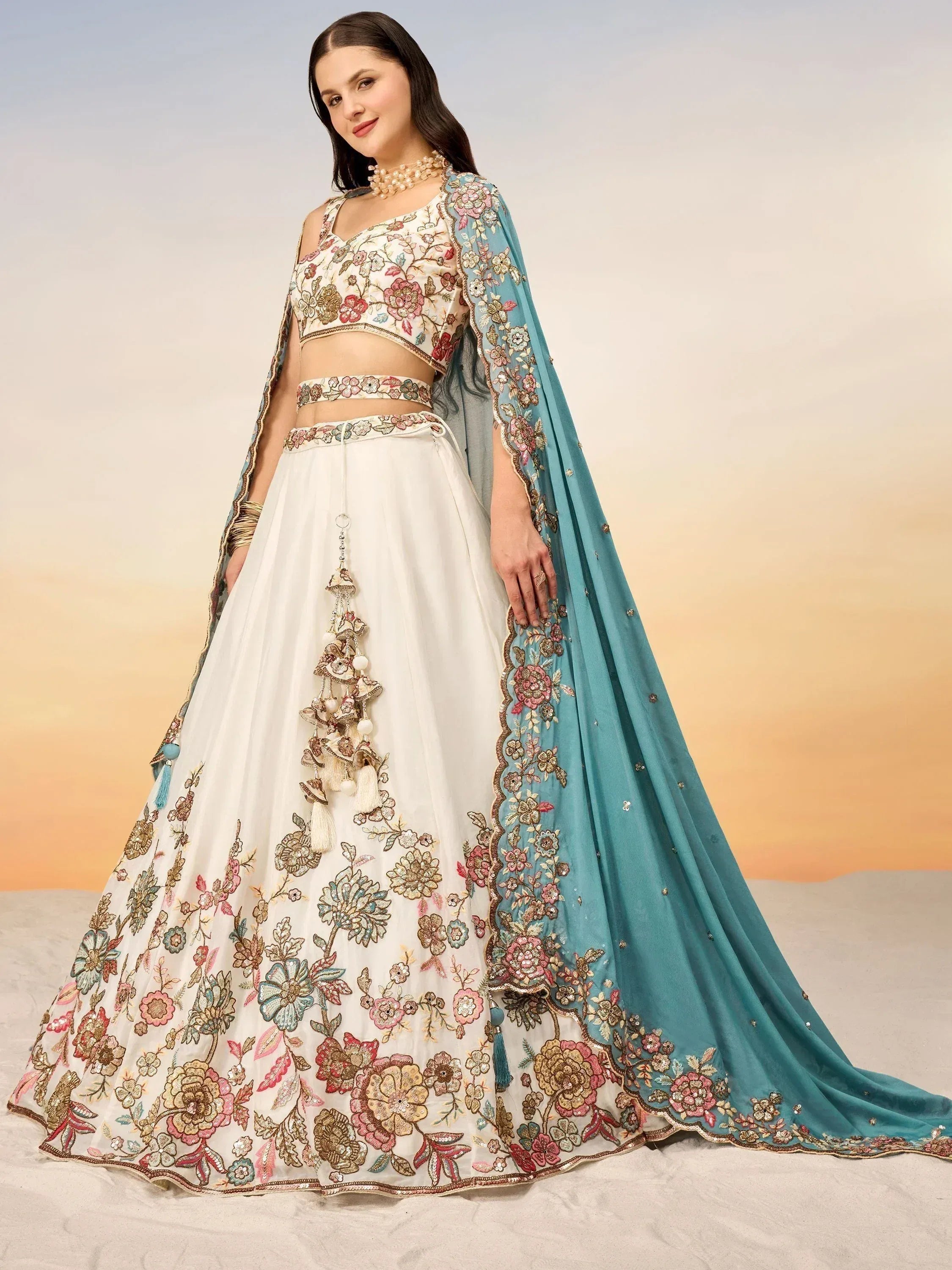 Elegant white lehenga choli with floral embroidery and teal dupatta for Indian ethnic wear
