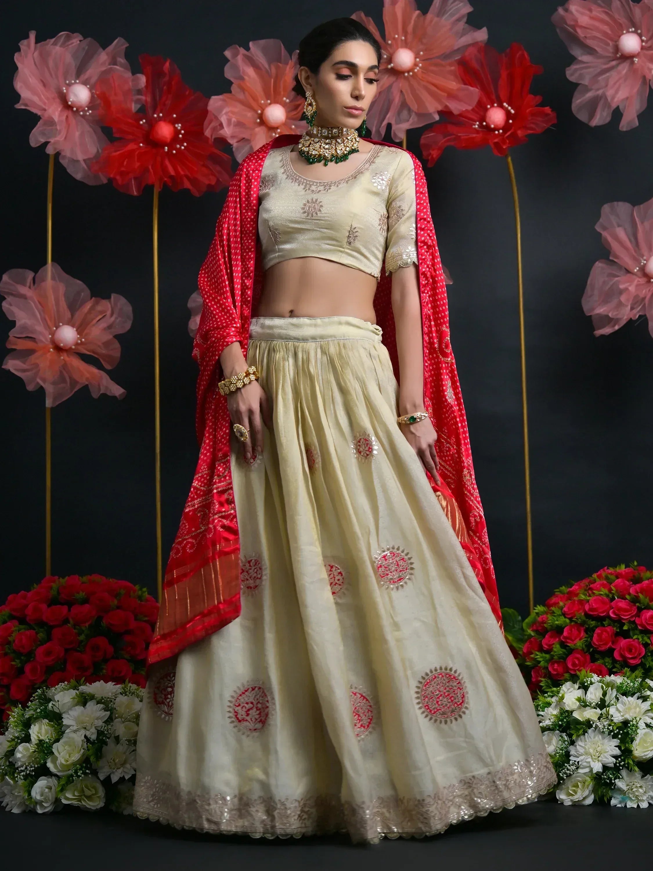 Cream embroidered lehenga choli with red dupatta, perfect for Indian weddings and festive occasions.