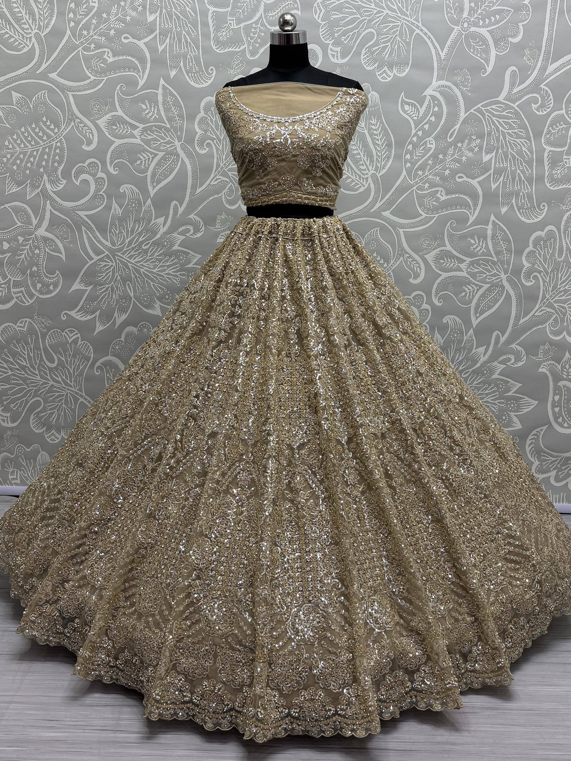 Gold embroidered lehenga choli with off-shoulder blouse, perfect for Indian weddings and festive occasions.