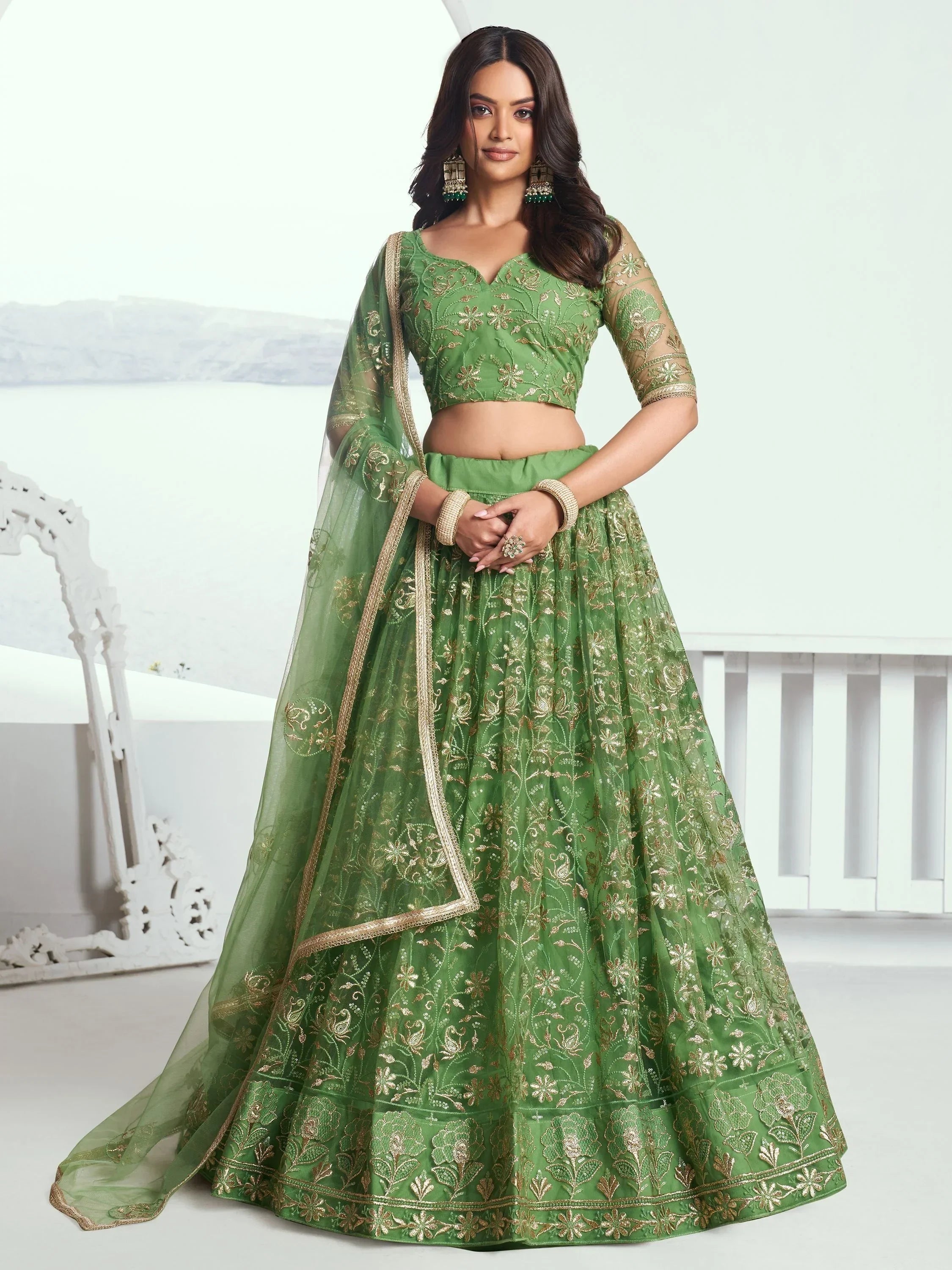 Green embroidered lehenga choli with gold detailing, perfect for ethnic occasions.