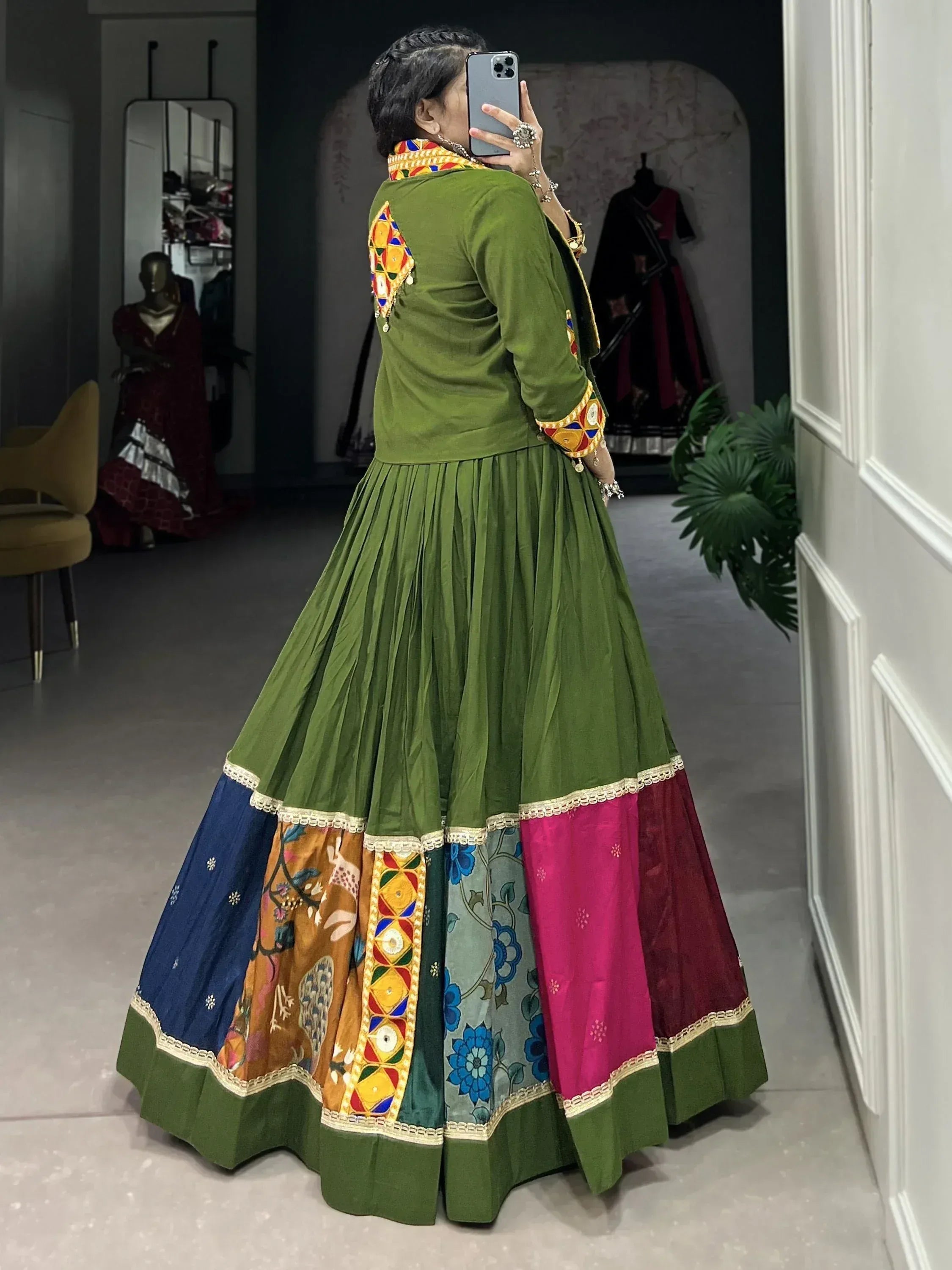 Green ethnic lehenga choli with colorful patchwork skirt and mirror work, perfect for Indian weddings or festivals.