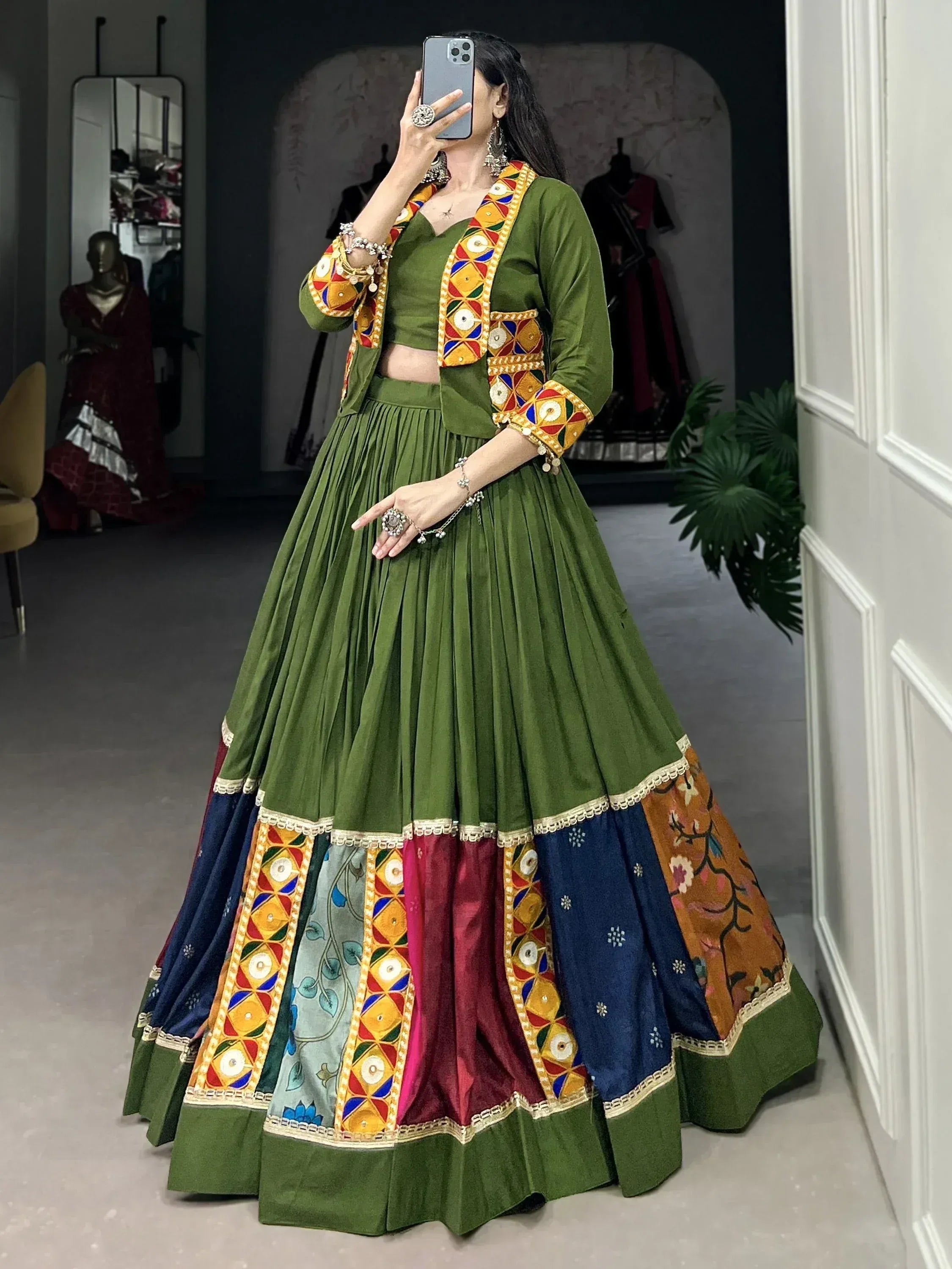 Green ethnic lehenga choli with colorful mirror work and patchwork skirt, perfect for festive occasions.